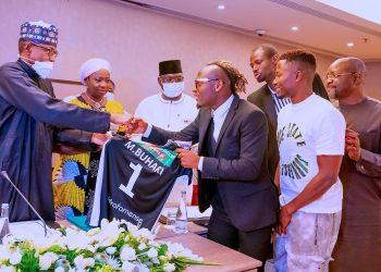 Super Eagles hopeful presents jersey to Buhari in Portugal