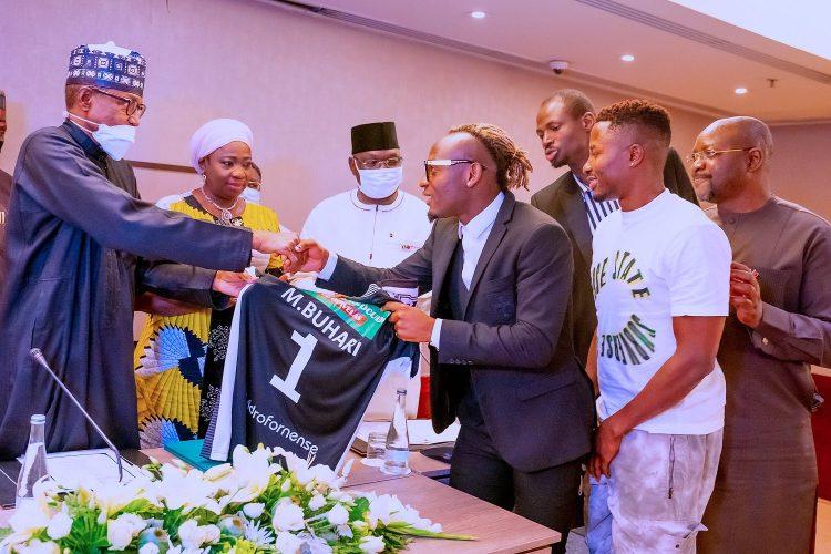 Super Eagles hopeful presents jersey to Buhari in Portugal