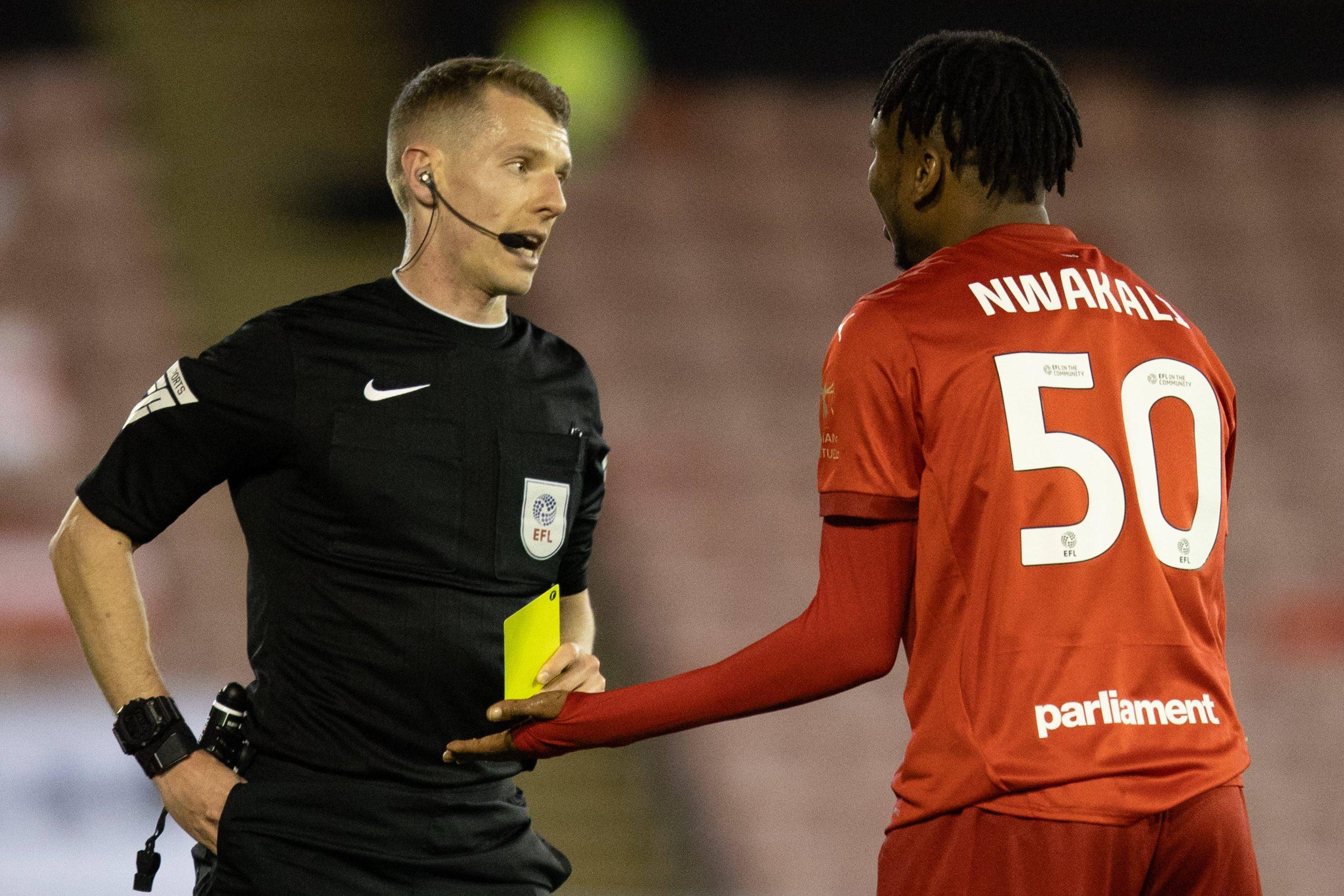 Ex Arsenal star Kelechi Nwakali of Barnsley is shown a yellow card