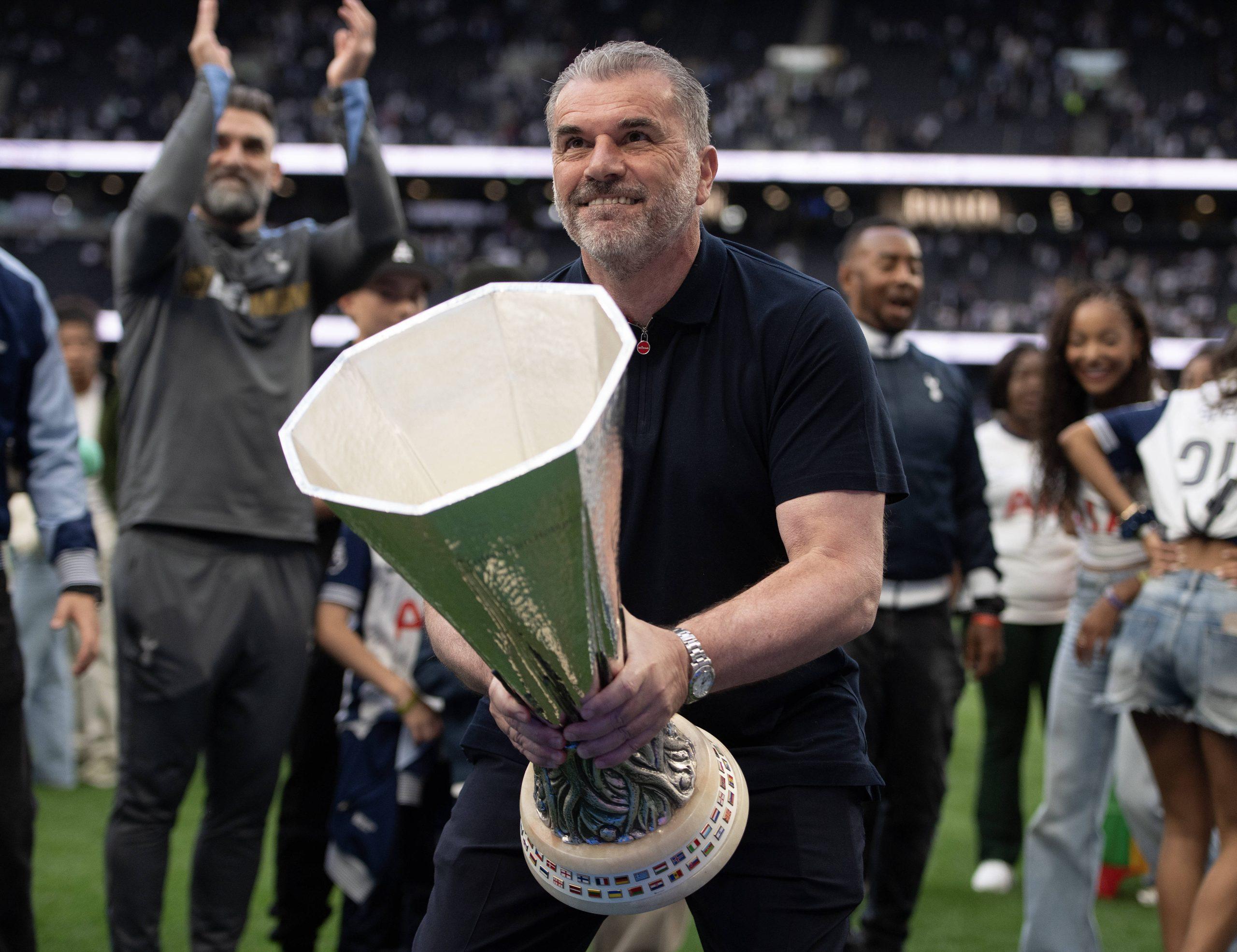 Tottenham Hotspur Head Coach Ange Postecoglou lifts the UEFA Europa League trophy after the Premier League match between Tottenham Hotspur FC and Brighton