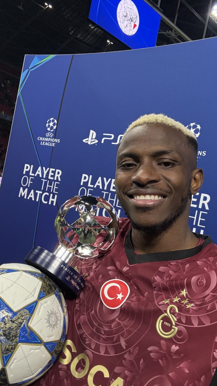 Victor Osimhen with his man of the match award after netting a hat-trick vs Ajax