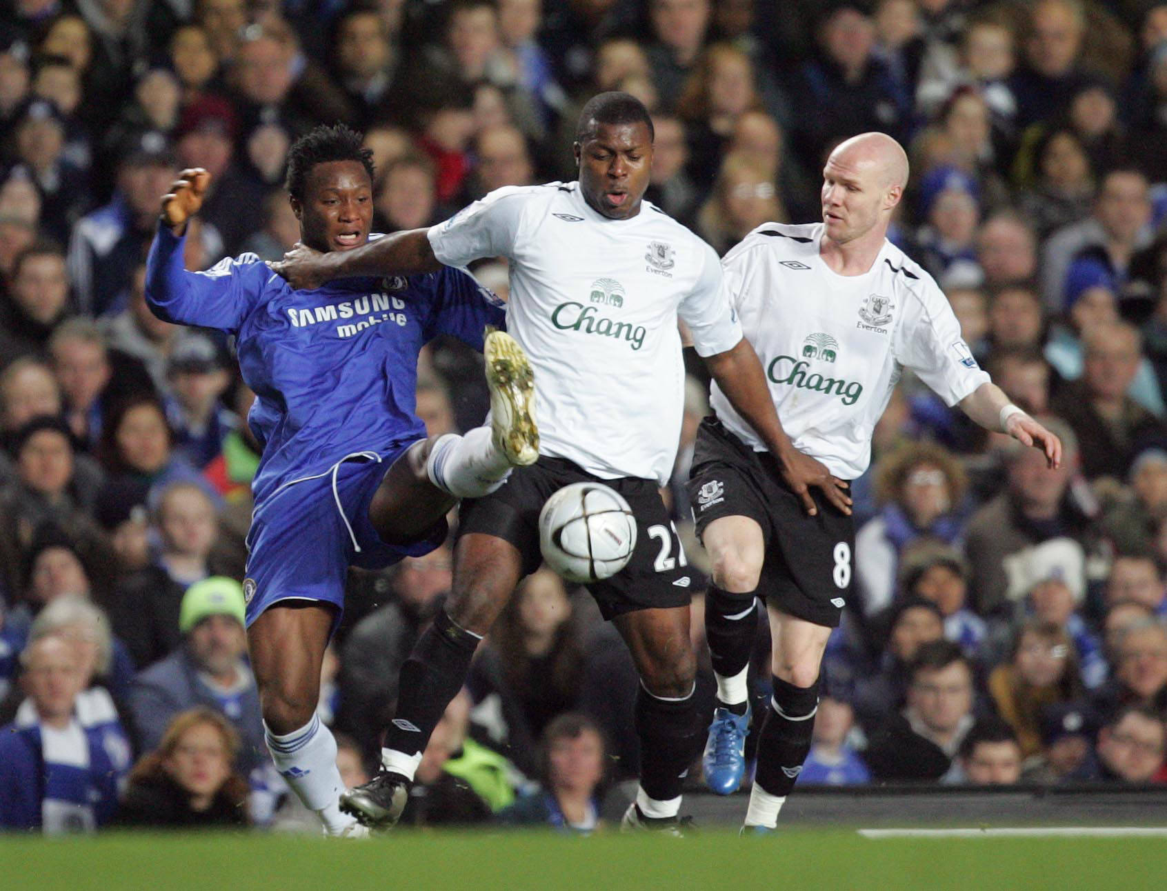 Mikel Obi tussles with Everton's Ayegbeni Yakubu and Andrew Johnson
