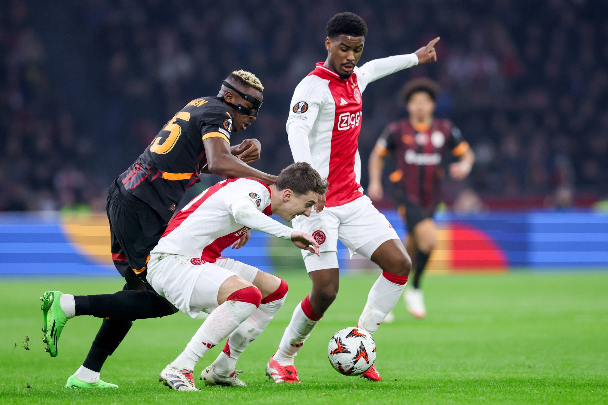 Youri Baas of AFC Ajax battles for possession with Victor Osimhen