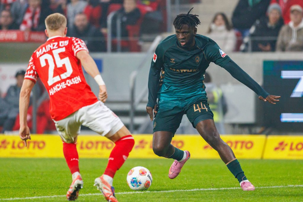 Victor Boniface with ball against Andreas Hanche Olsen during Bundesliga match between 1 FSV Mainz 05 and Borussia Dortmund