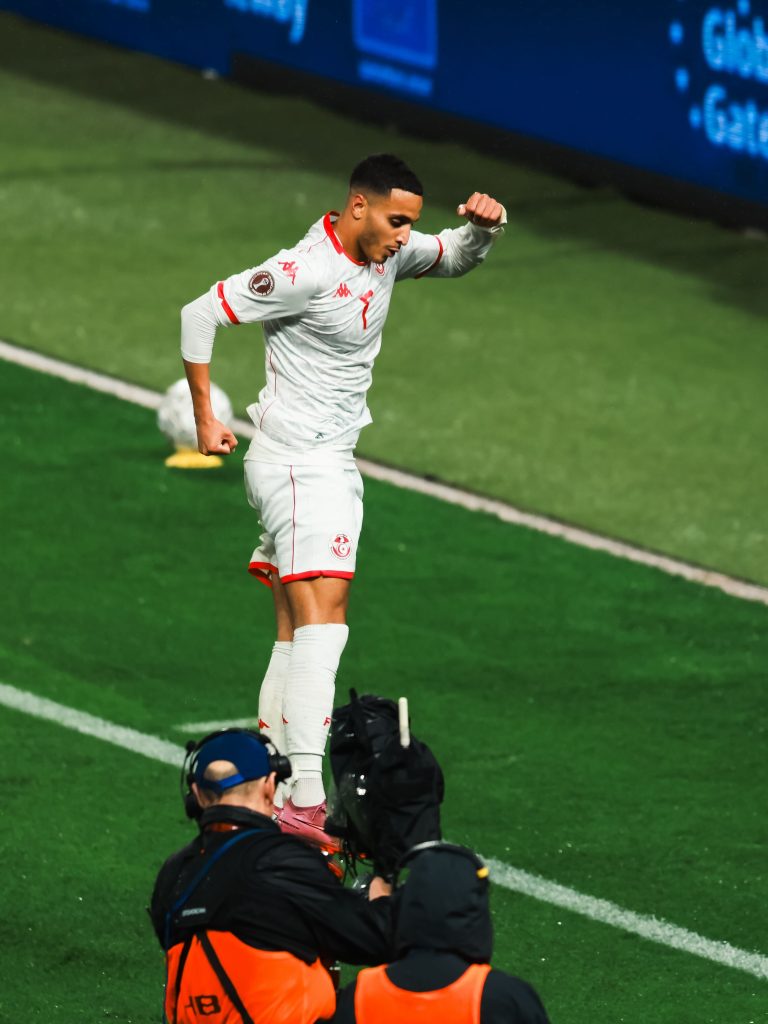 Elias Achouri celebrating after putting Tunisia 3-0 up against Uganda