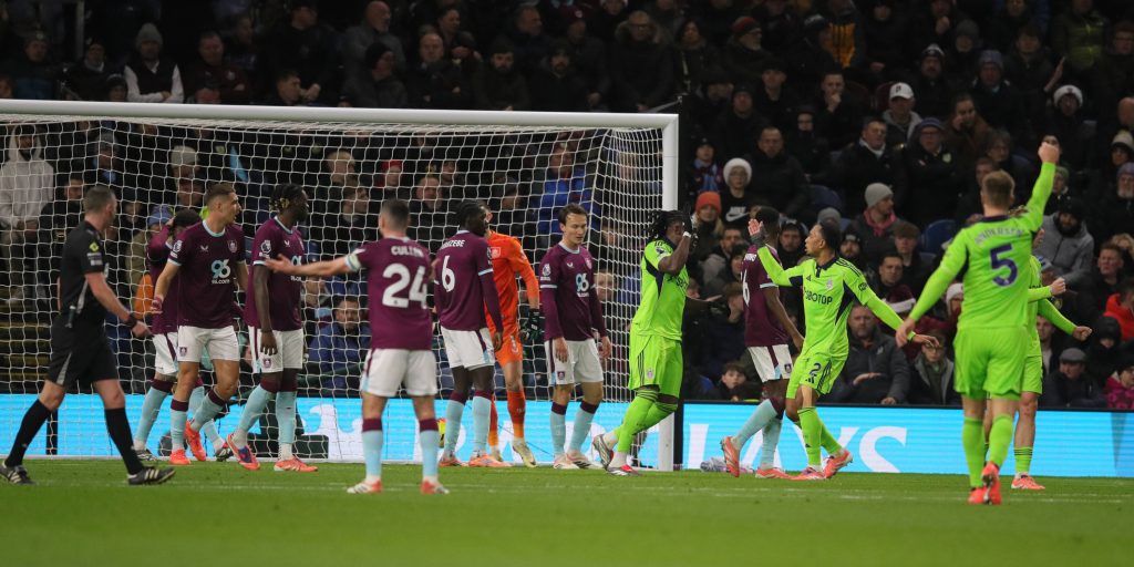 Calvin Bassey celebrates scoring their second goal with Kenny Tete during the Premier League match between Burnley and Fulham