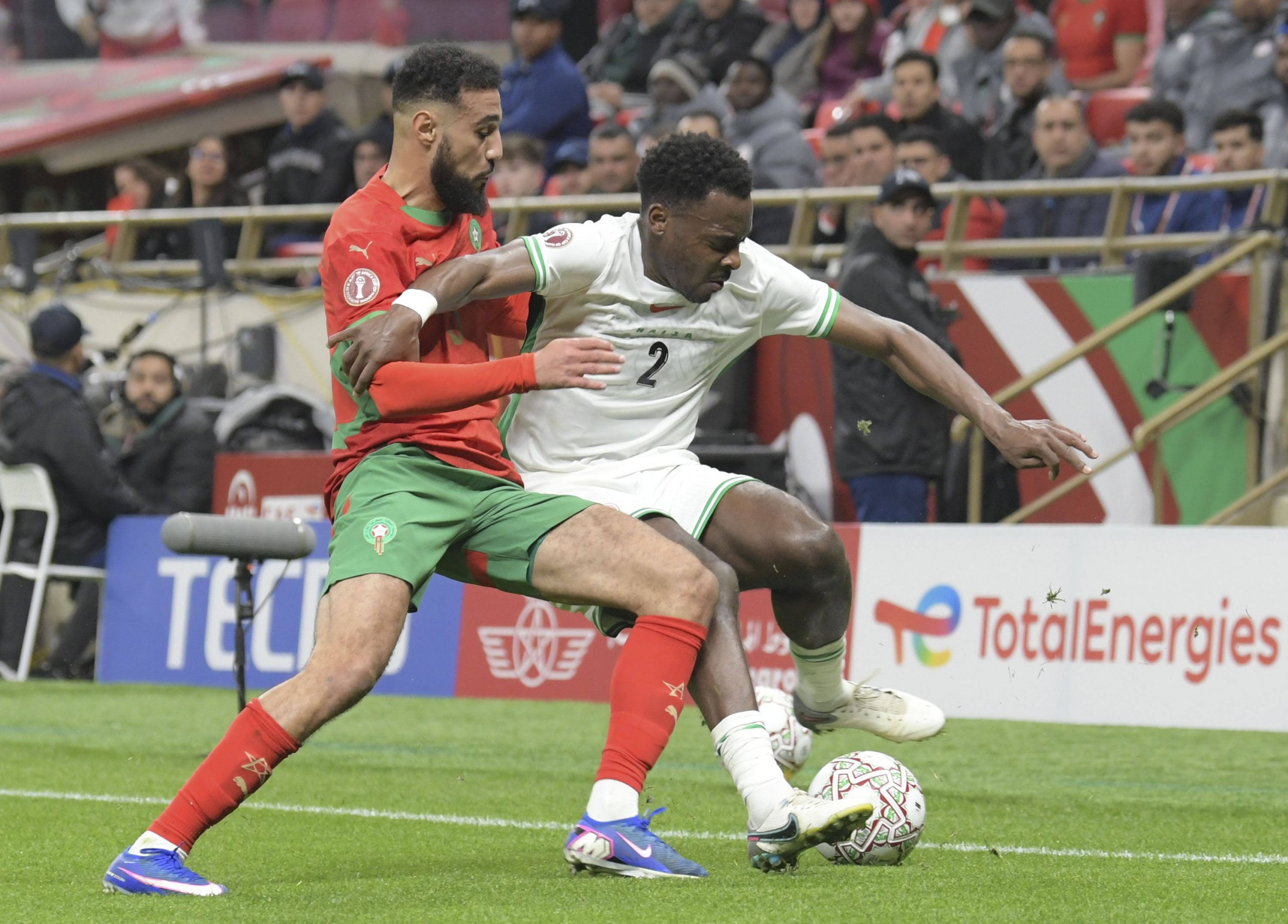 Bright Osayi-Samuel R vies against Noussair Mazraoui during the Africa Cup of Nations semifinal match between Morocco and Nigeria