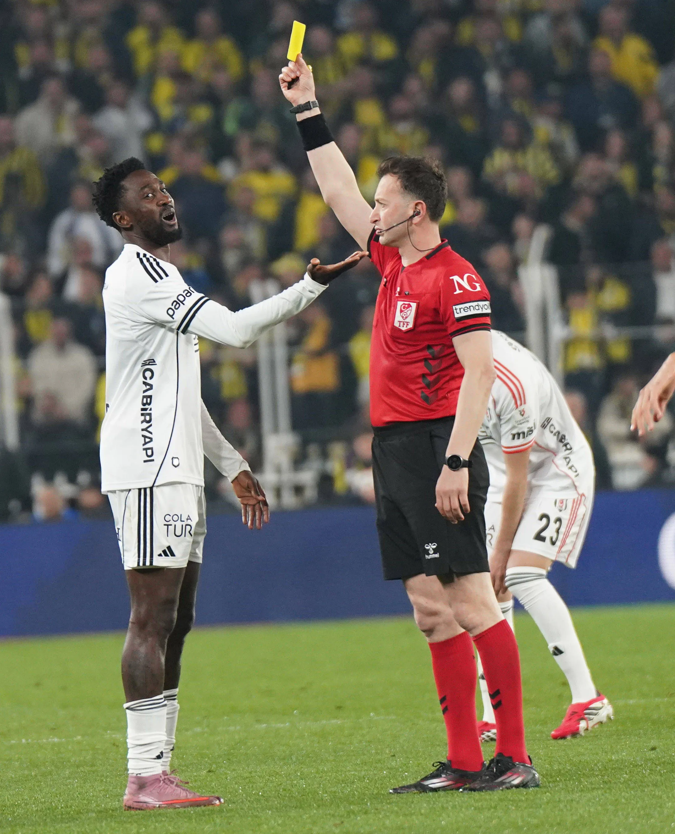 Referee Yasin Kol show yellow card to Wilfred Ndidi of Besiktas during the Trendyol Turkish Süper League match between Fenerbahce SK and Besiktas JK at Chobani Stadium
