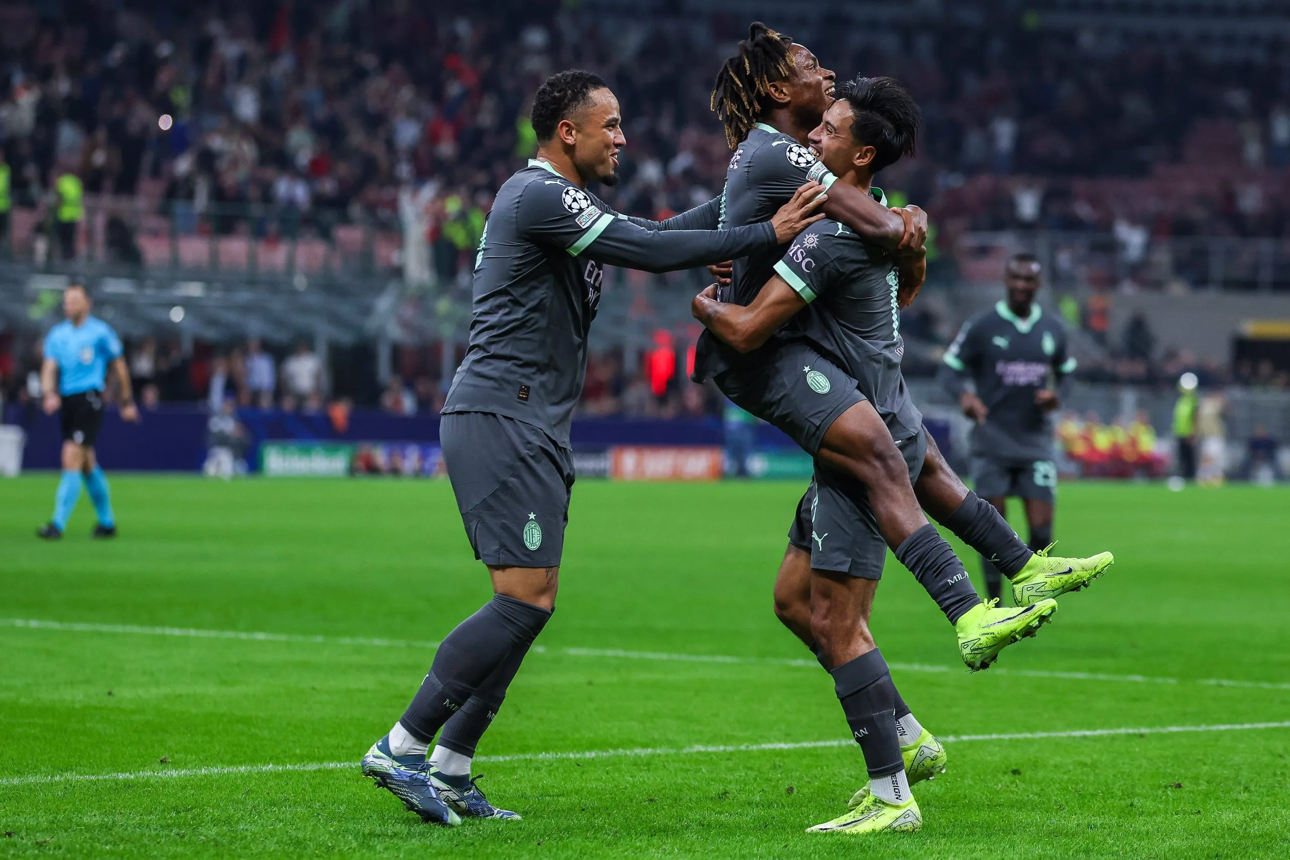 Tijjani Reijnders celebrates with his team mates Samuel Chukwueze and Noah Okafor after scoring a goal during UEFA Champions League match between AC Milan and Club Brugge KV