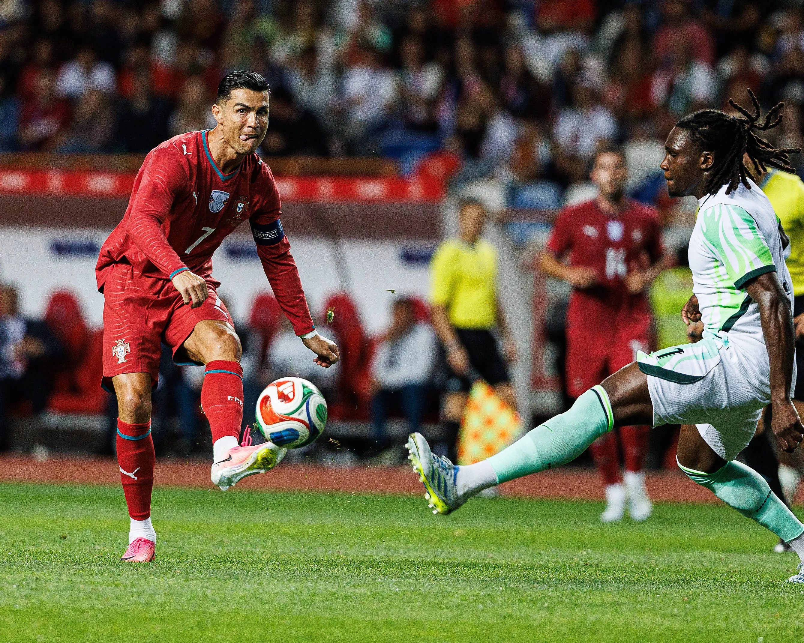 Cristiano Ronaldo of Portugal takes on Nigeria's Calvin Bassey