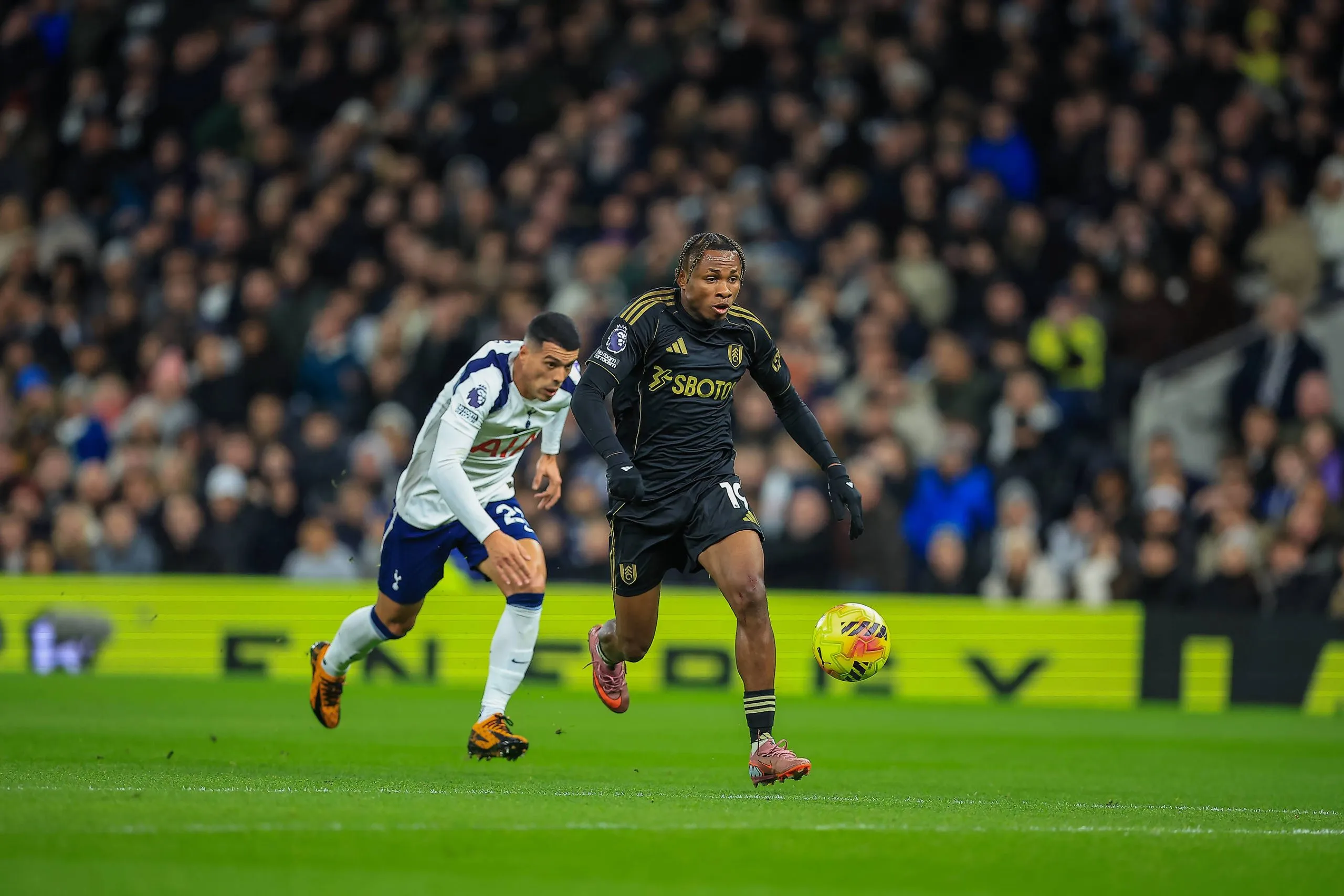 Samuel Chukwueze 19 Battles for the ball with Pedro Porro 23 during the Premier League match between Tottenham Hotspur and Fulham at Tottenham Hotspur Stadium