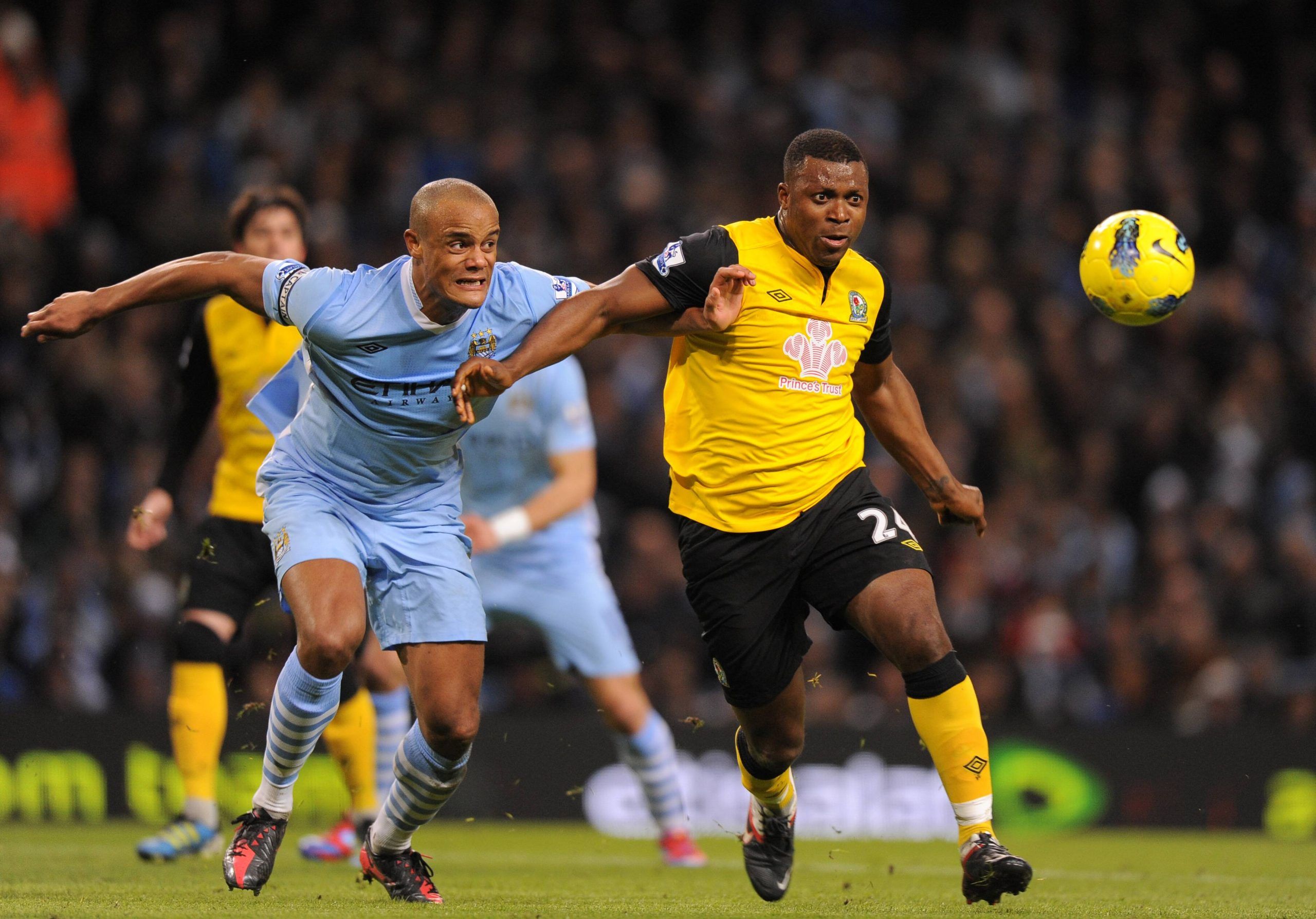 Vincent Kompany of Manchester City challenges Yakubu Aiyegbeni of Blackburn Rovers. 25th February 2012