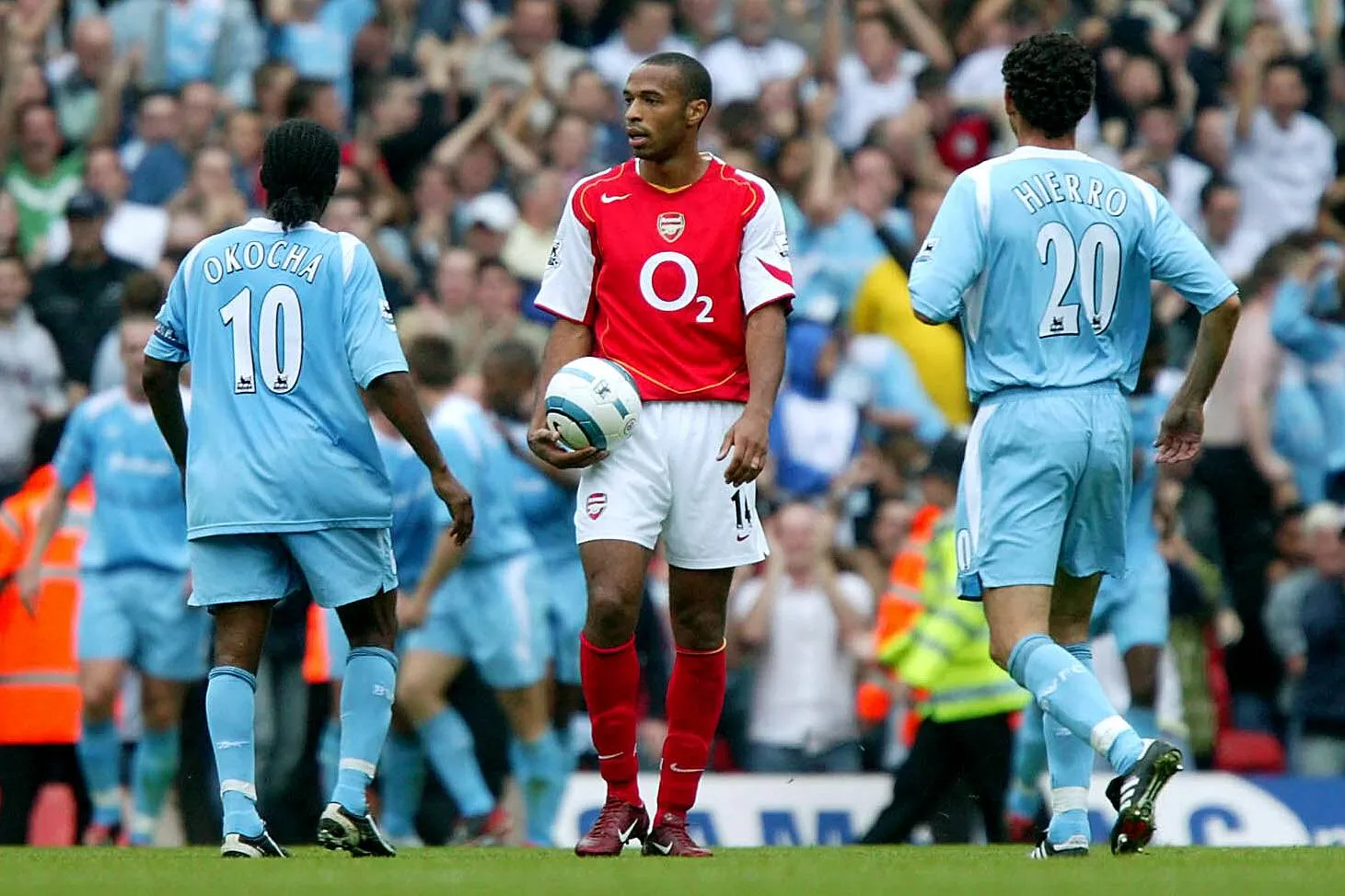 Thierry Henry holds the ball beside Okocha