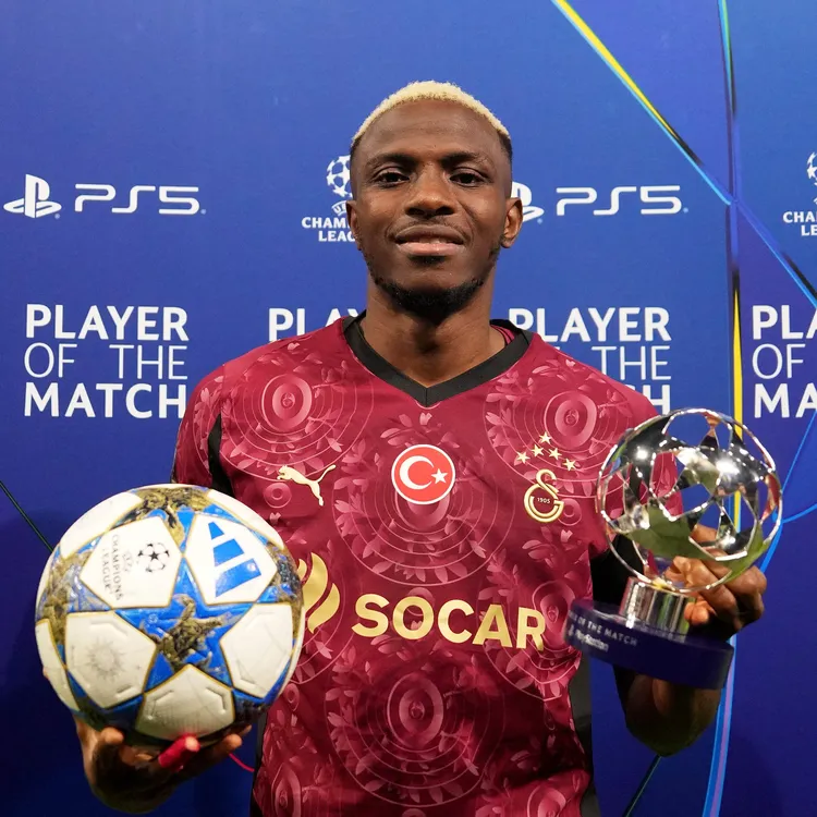 Victor Osimhen with his man of the match award after netting a hat-trick vs Ajax 