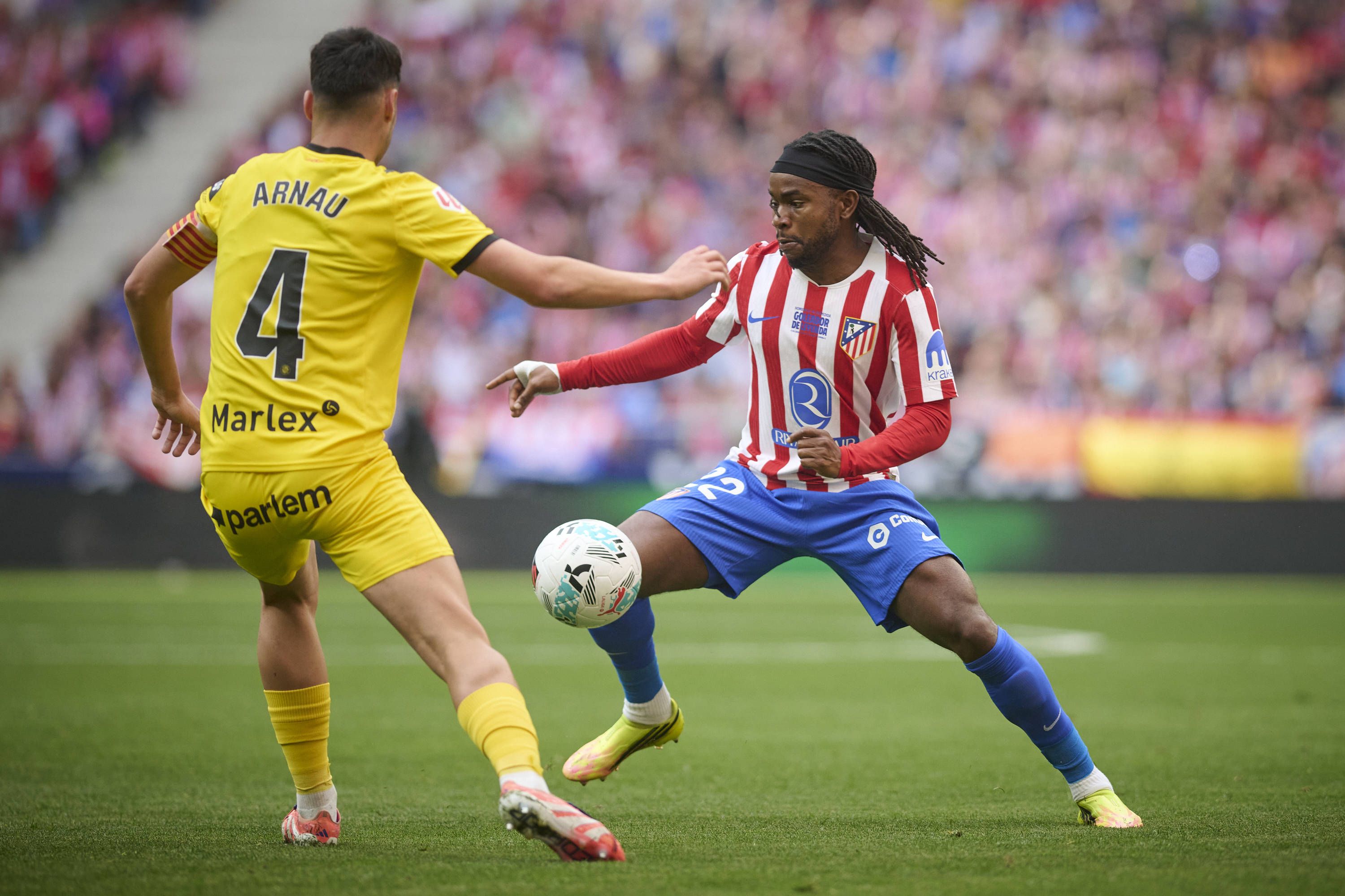 Ademola Lookman of Atletico Madrid against Girona FCs Arnau Martinez during La Liga match.