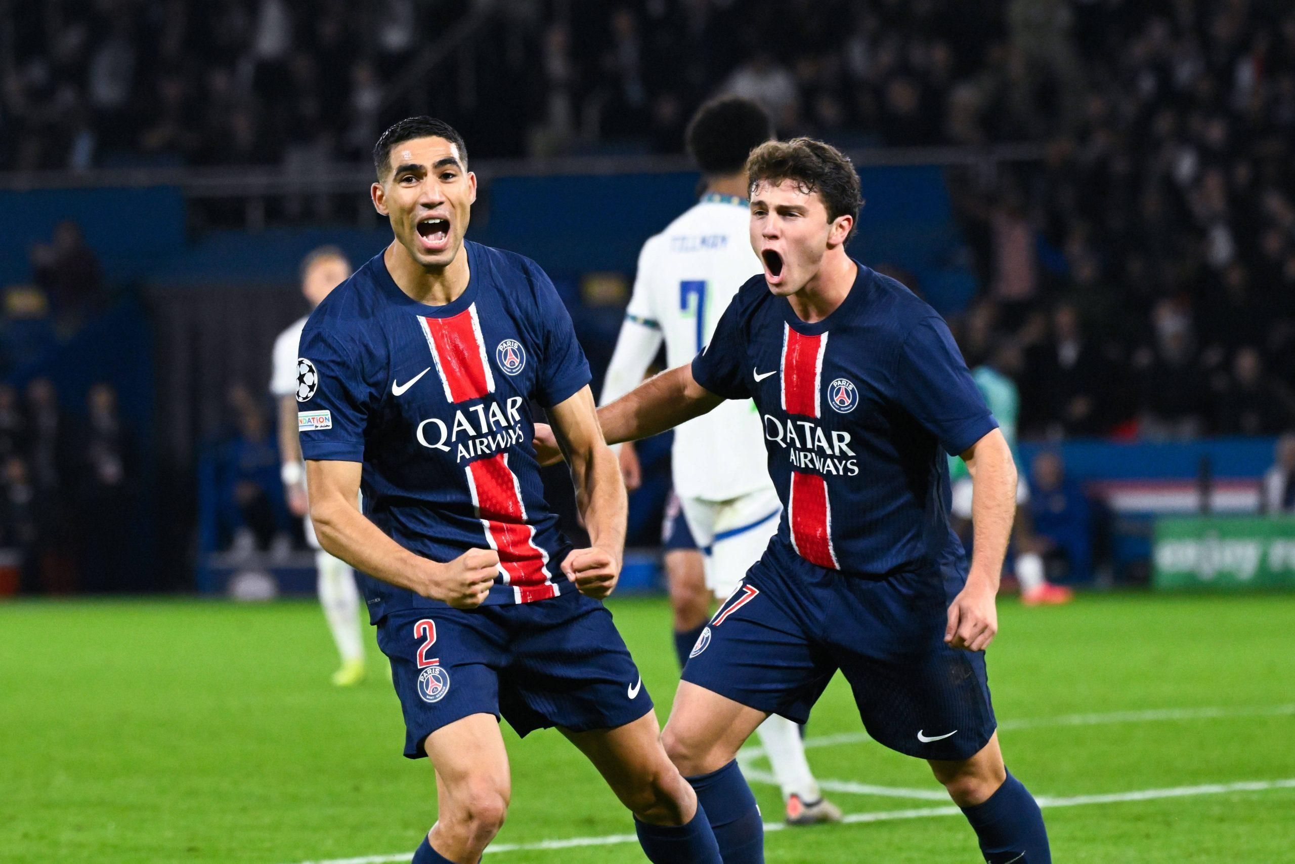 Achraf Hakimi celebrates with Joao Pedro Goncalves Neves during the UEFA Champions League match between Paris Saint-Germain and PSV Eindhoven