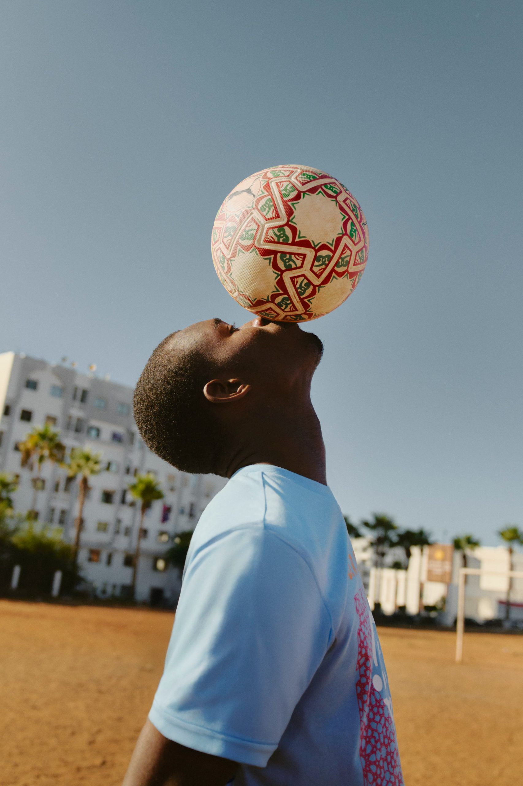 A boy kissing the AFCON 2025 official match ball 