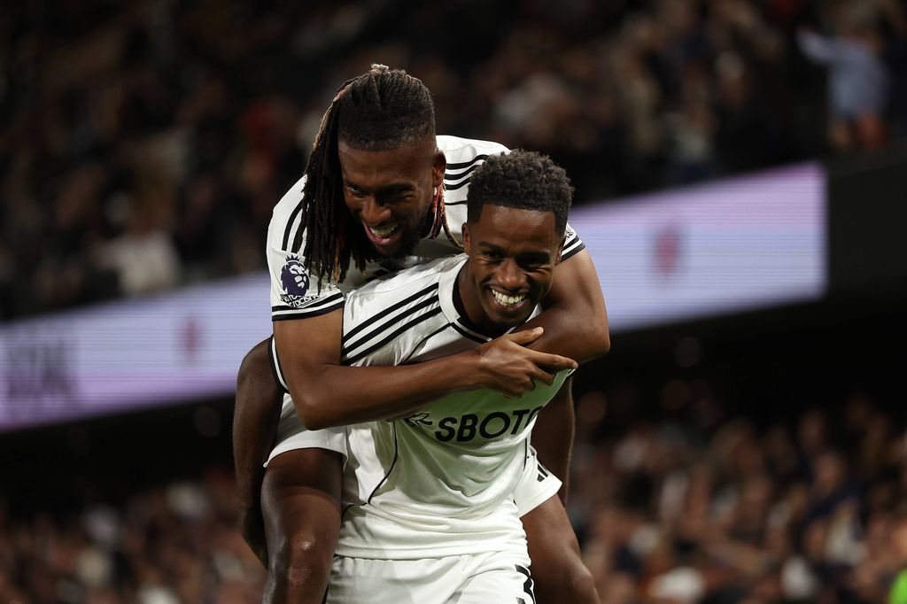 Ryan Sessegnon of Fulham celebrates with Alex Iwobi after his cross lead to Ethan Pinnock of Brentford scoring an own goal in the 50th minute to make it 3-1