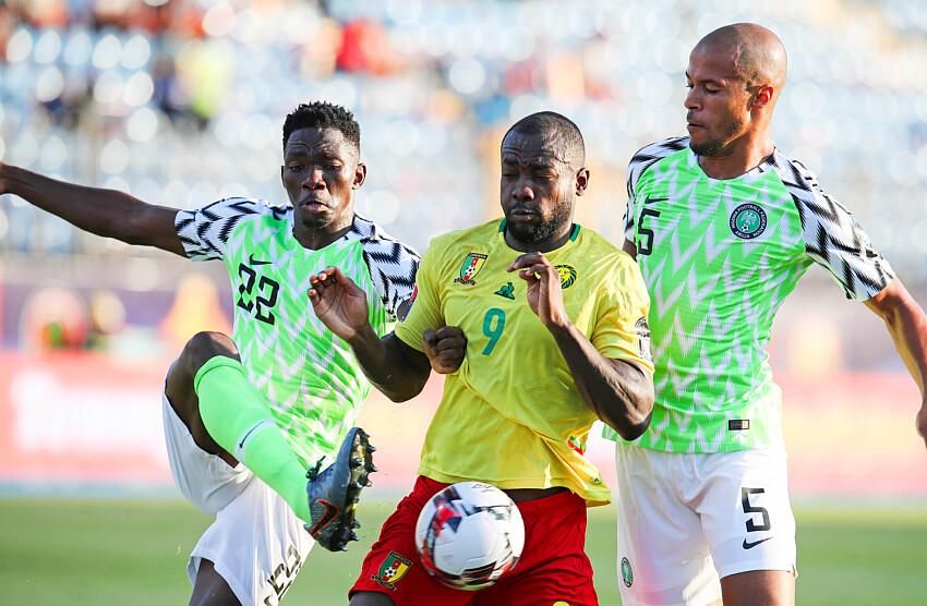 Stephane Bahoken of Cameroon challenged by Josiah Kenneth Omeruo (l) and William Paul Ekong of Nigeria during the 2019 Africa Cup of Nations Last 16 match between Nigeria and Cameroon.