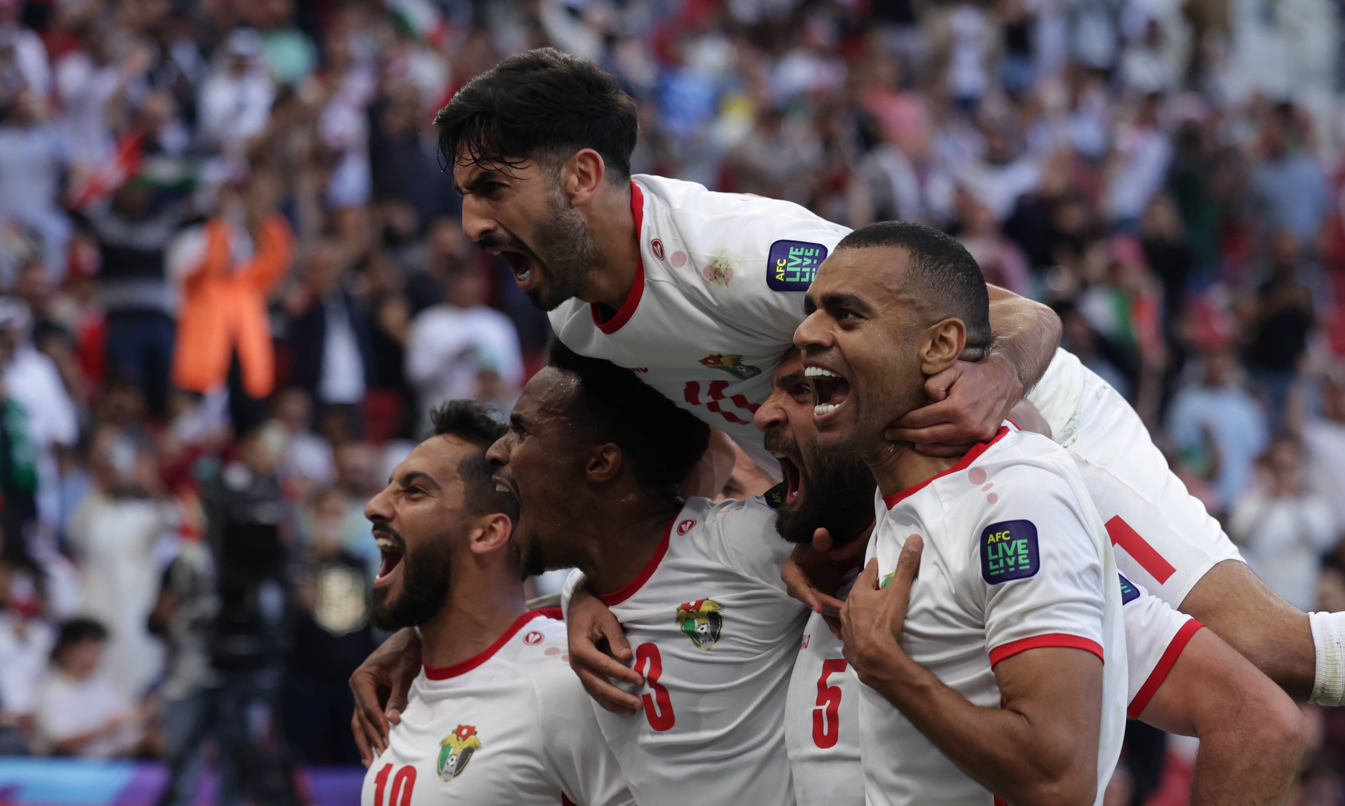  Yazan Al-Arab of Jordan celebrates with Musa Al-Taamari, Abdallah Nasib, Yazan Al-Naimat after scoring goal during the AFC Asia Cup match between Jordan and South Korea