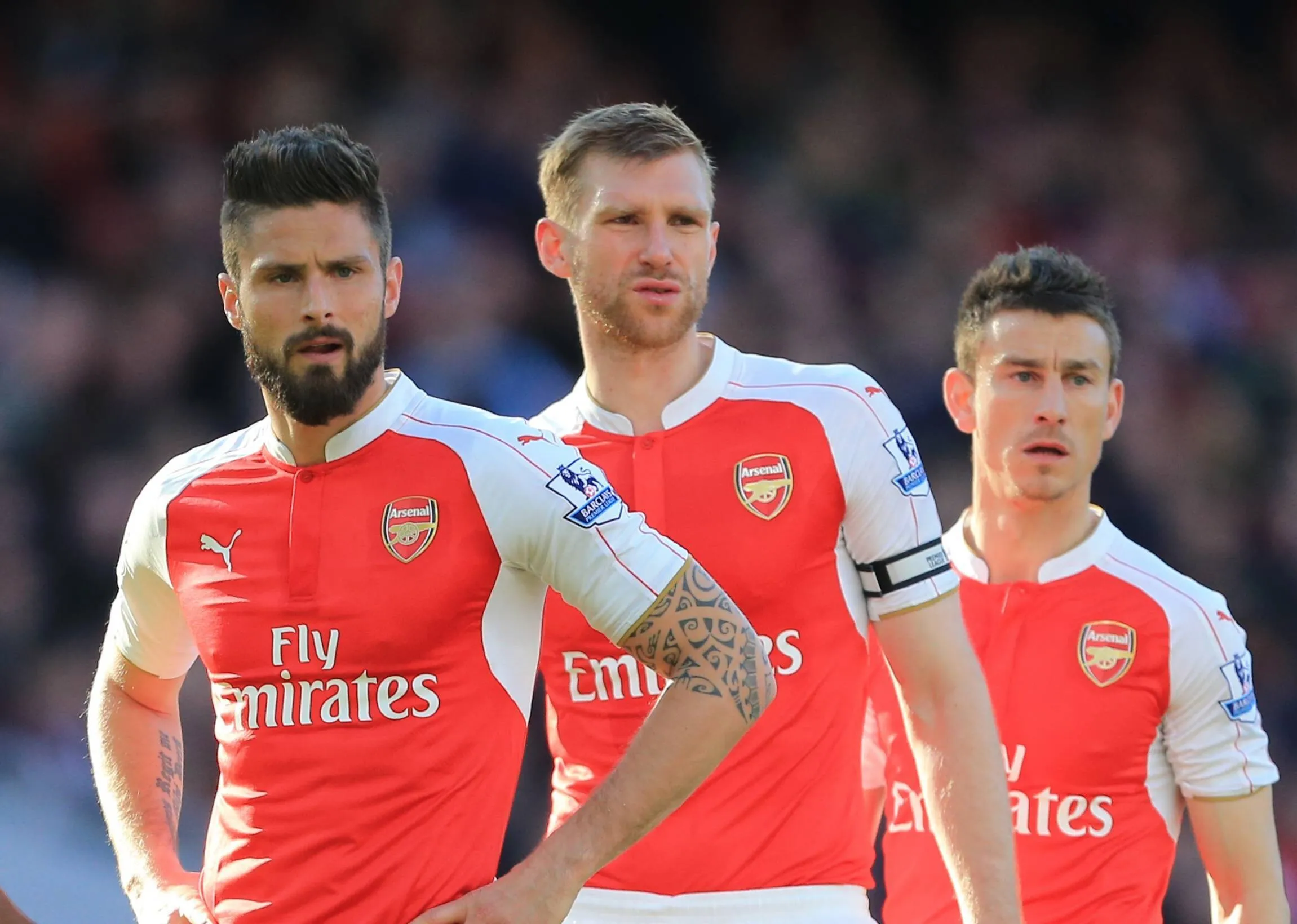 Olivier Giroud and Per Mertesacker look on dejected during the Barclays Premier League match at the Emirates Stadium. 
