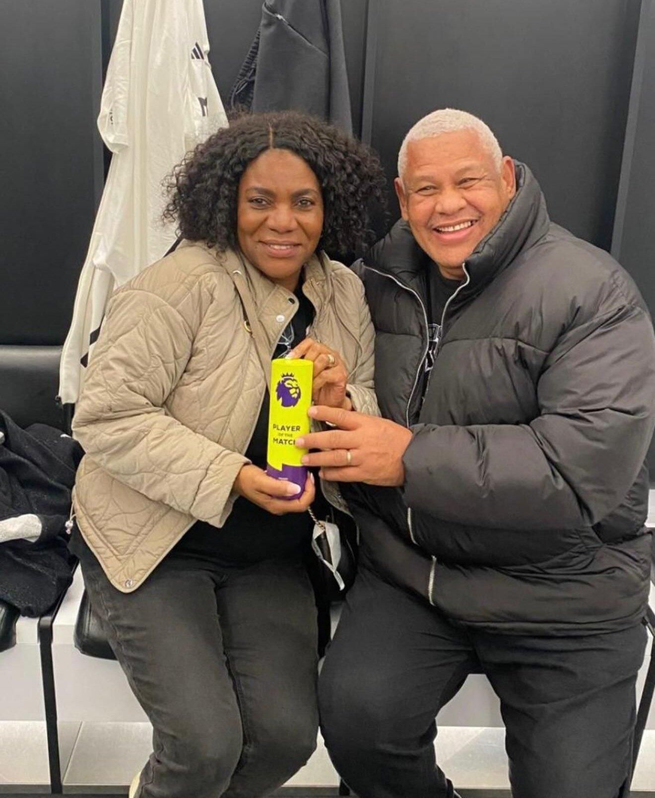 Alex Iwobi's parents posing with MOTM award