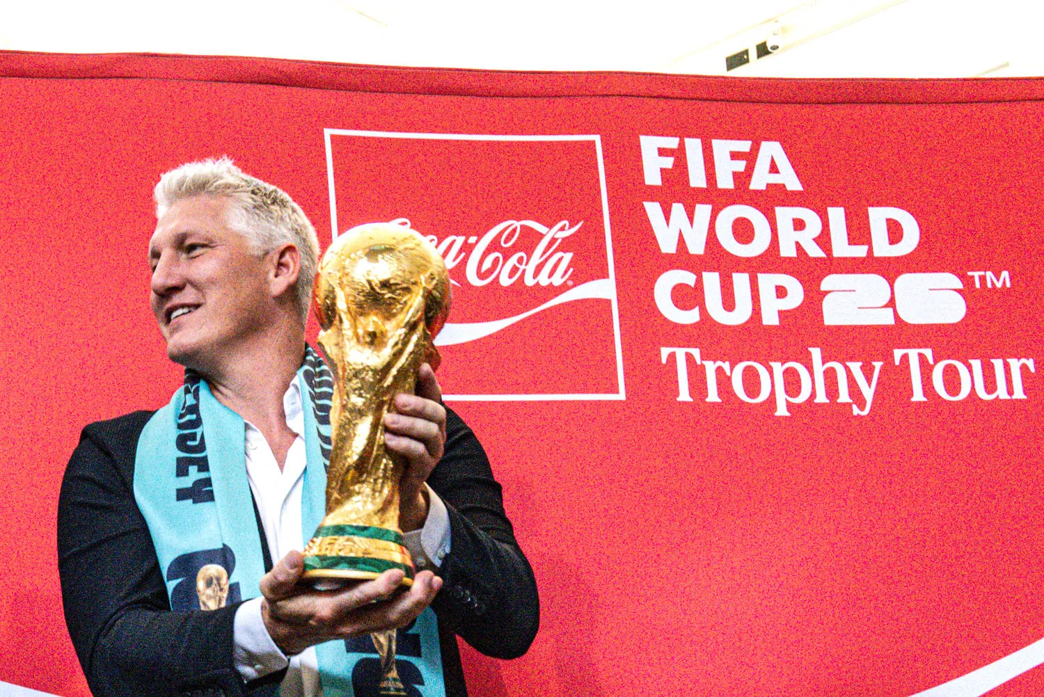 German former footballer Bastian Schweinsteiger holds up the coveted 2026 FIFA World Cup trophy