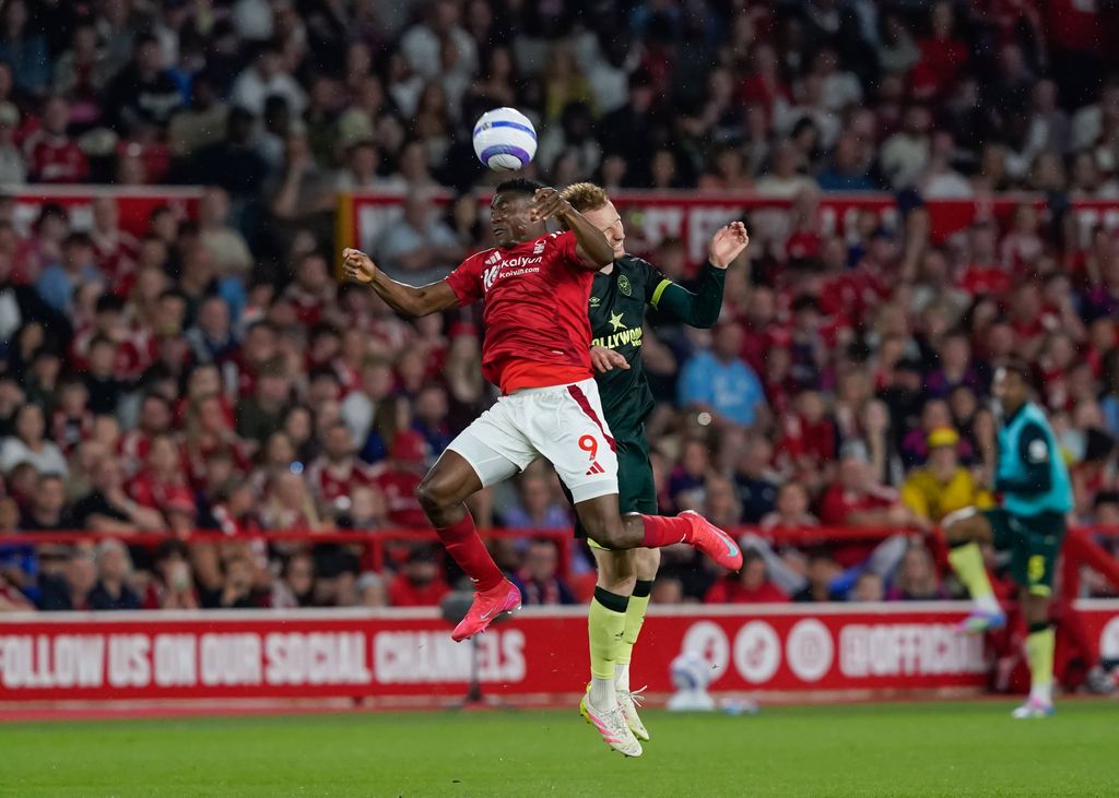 Taiwo Awoniyi and Sepp van den Berg of Brentford battle for the ball during the Nottingham Forest vs Brentford