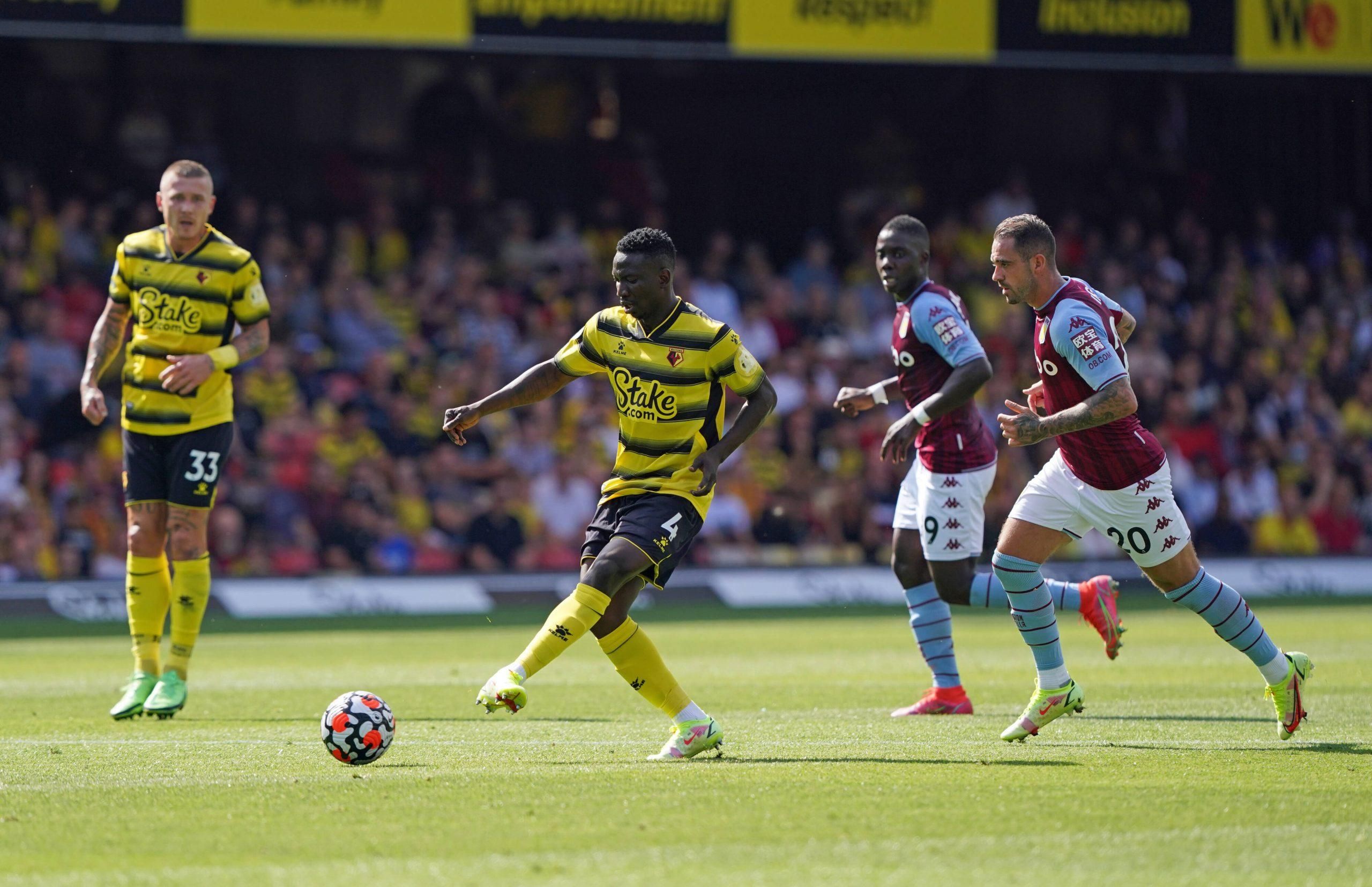 Watford s Peter Etebo left strikes the ball away from Aston Villa s Danny Ings right during the Premier League match 