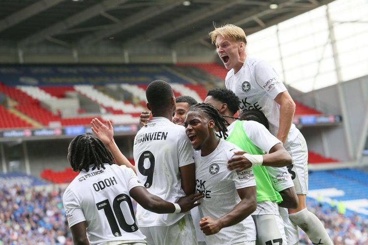 Abraham Odoh celebrates with Bradley Ihionvien and Peterborough United teammates