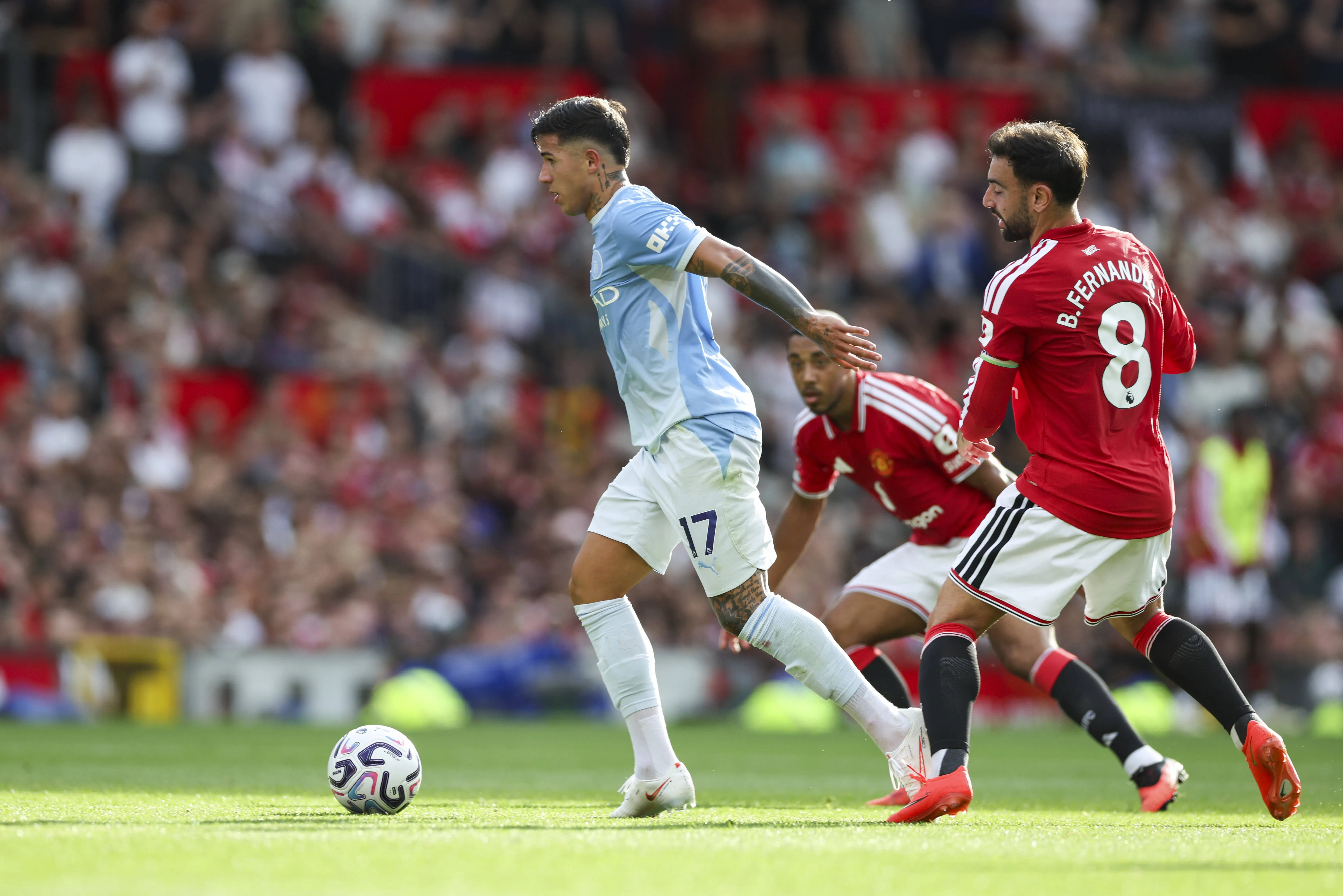 Manchester City midfielder Enzo Fernandez battles with Bruno Fernandes