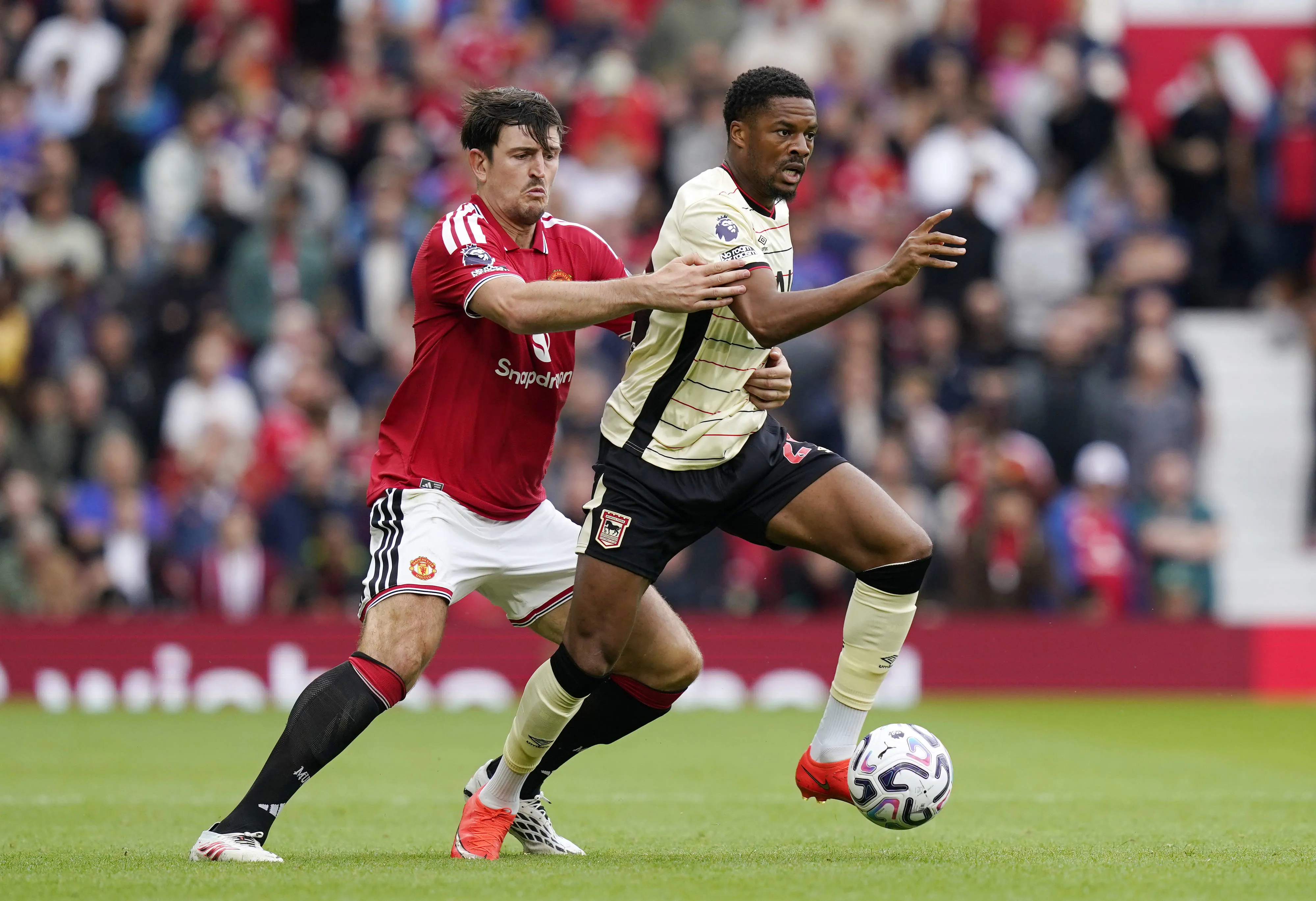 Harry Maguire of Manchester United, ManU tackles Chuba Akpom of Ipswich Town