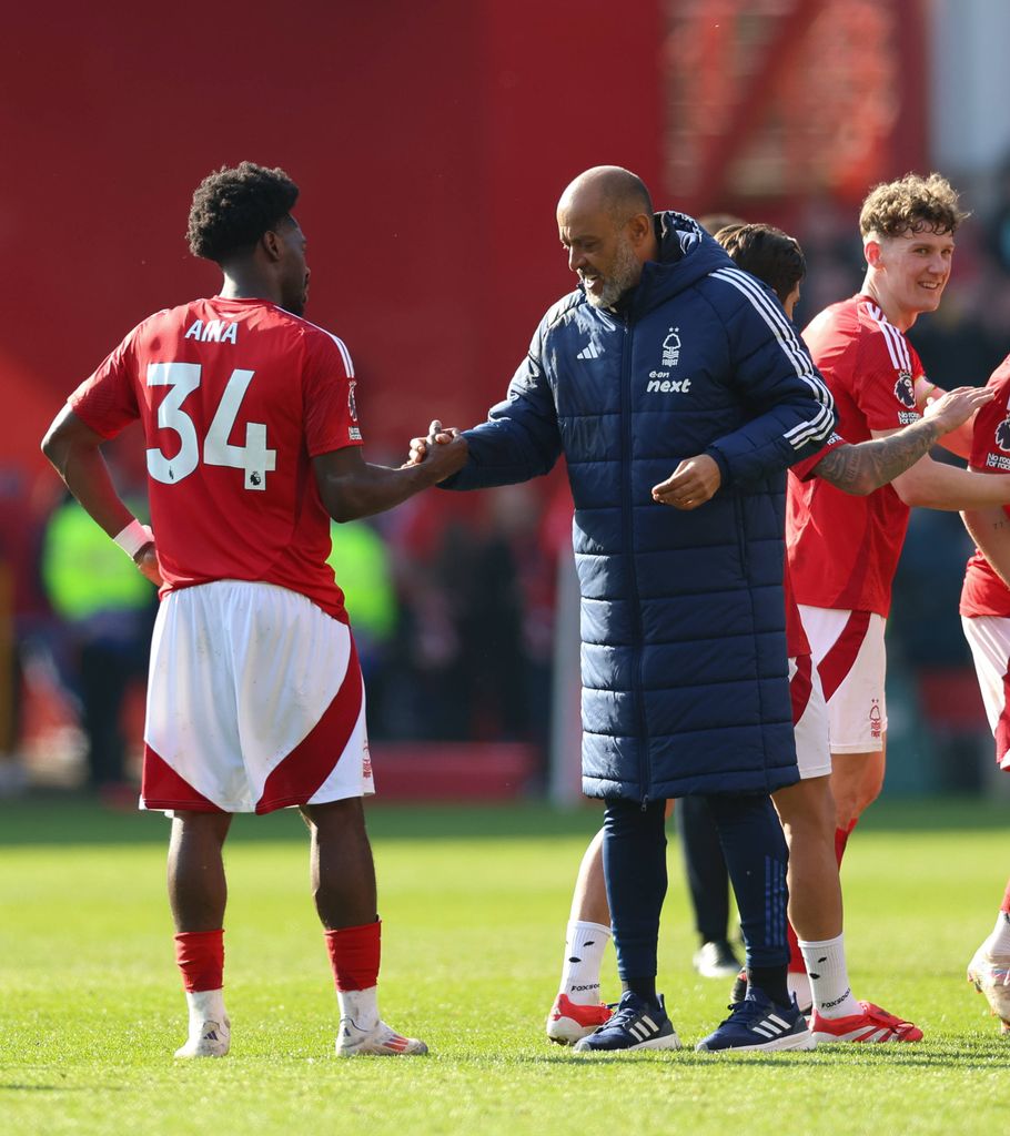 Nuno Espirito Santo congratulates Ola Aina on winning the game during the Premier League match at the City Ground