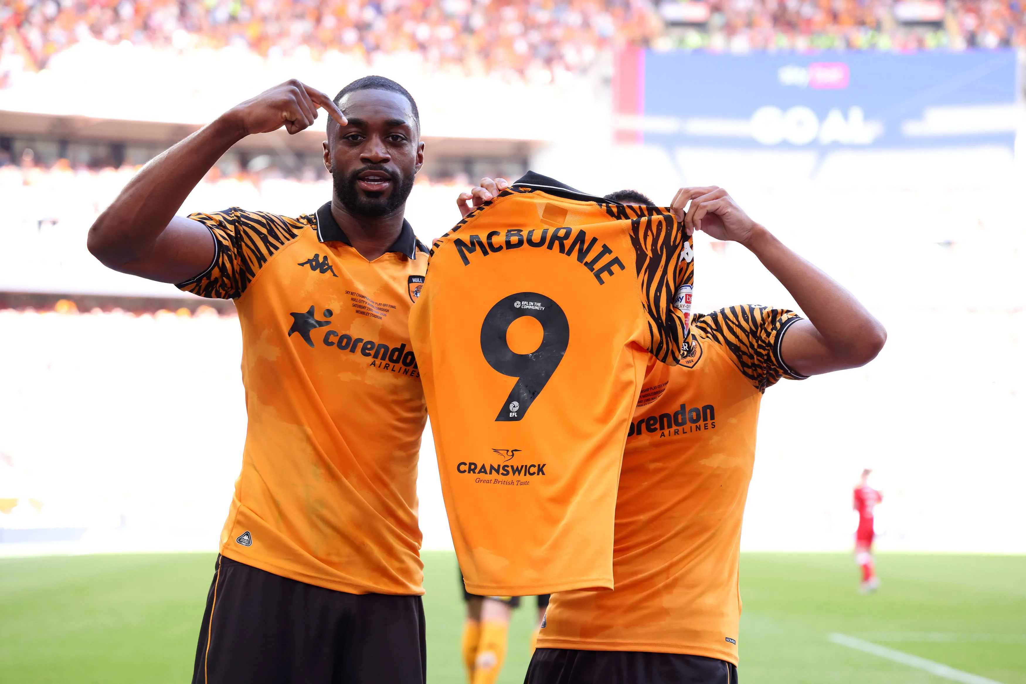 Semi Ajayi and Cody Drameh of Hull City celebrate with Oliver McBurnie's shirt