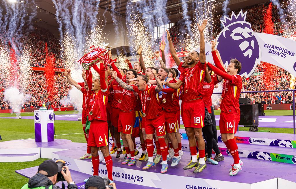 Liverpool players celebrating with the Premier League trophy in May 2025