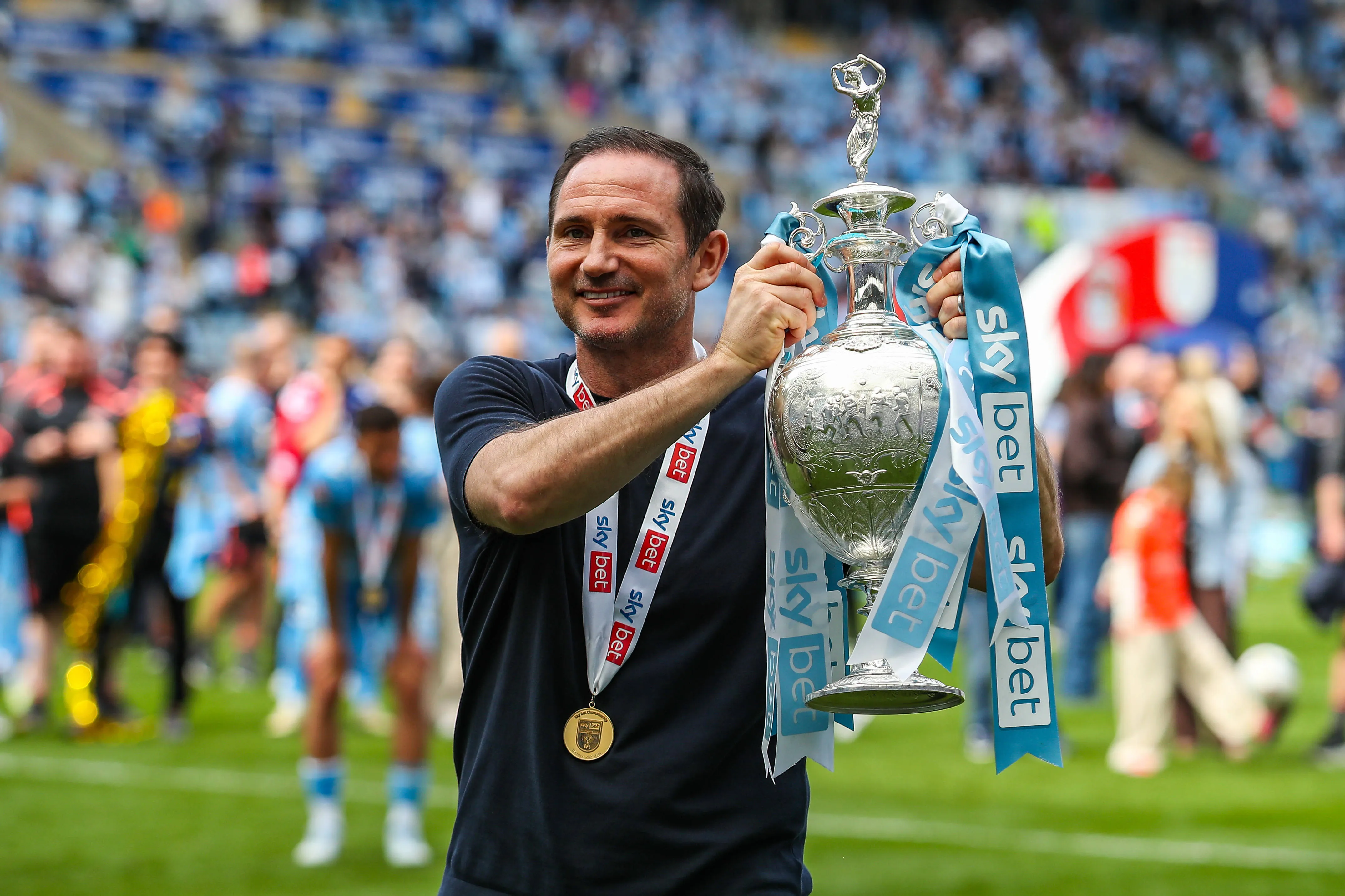 Coventry City Manager Frank Lampard holds up the Sky Bet Championship trophy during the Coventry City v Wrexham Sky Bet Championship match at Coventry Building Society Arena