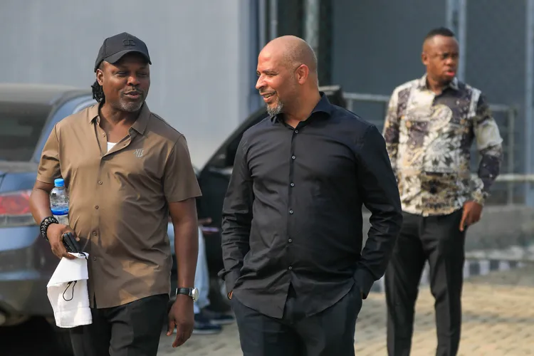 Nigeria Super Eagles coach Eric Chelle and former Super Eagles striker Victor Ikpeba.