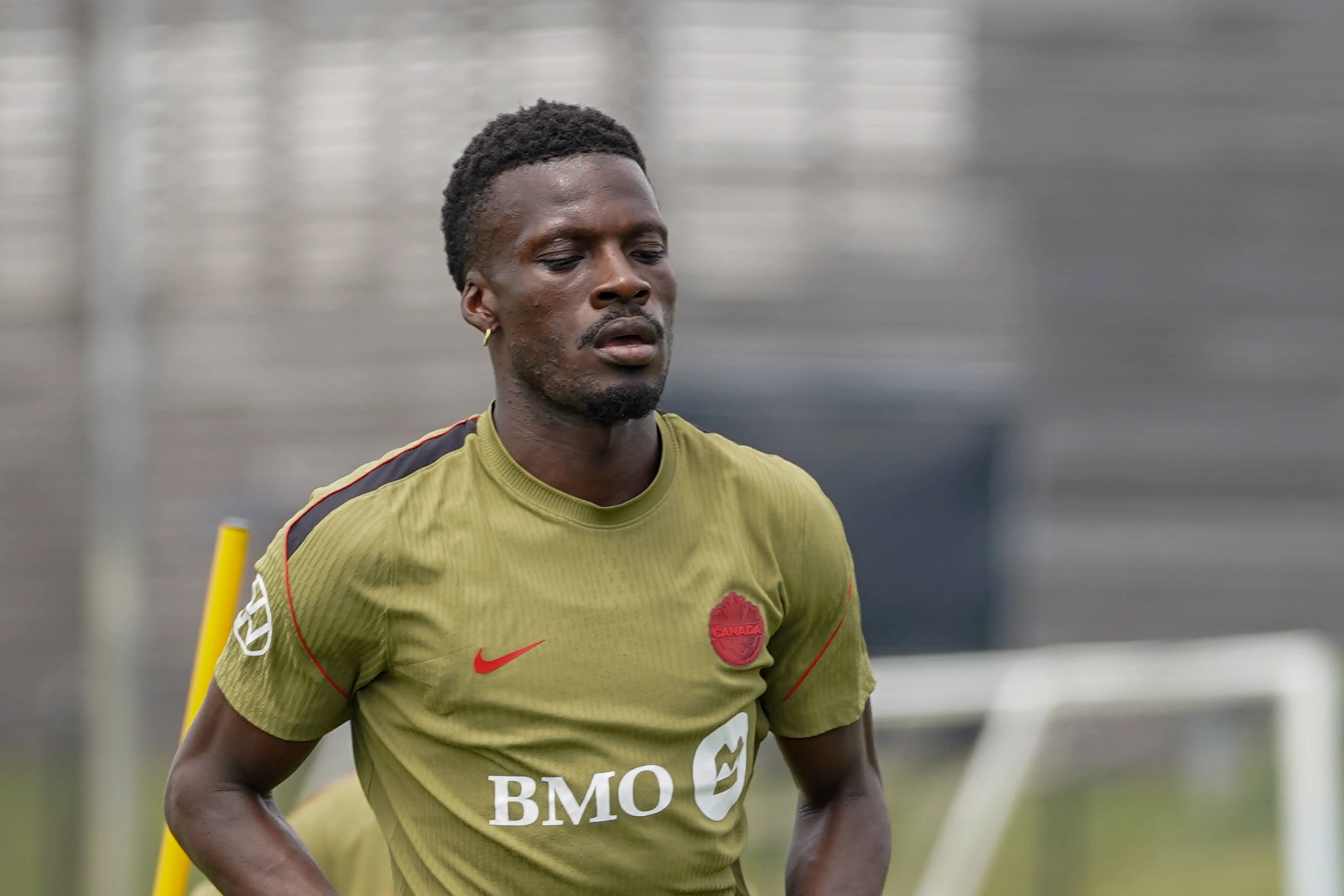 Tani OLUWASEYI 12 of Canada national football team warms-up