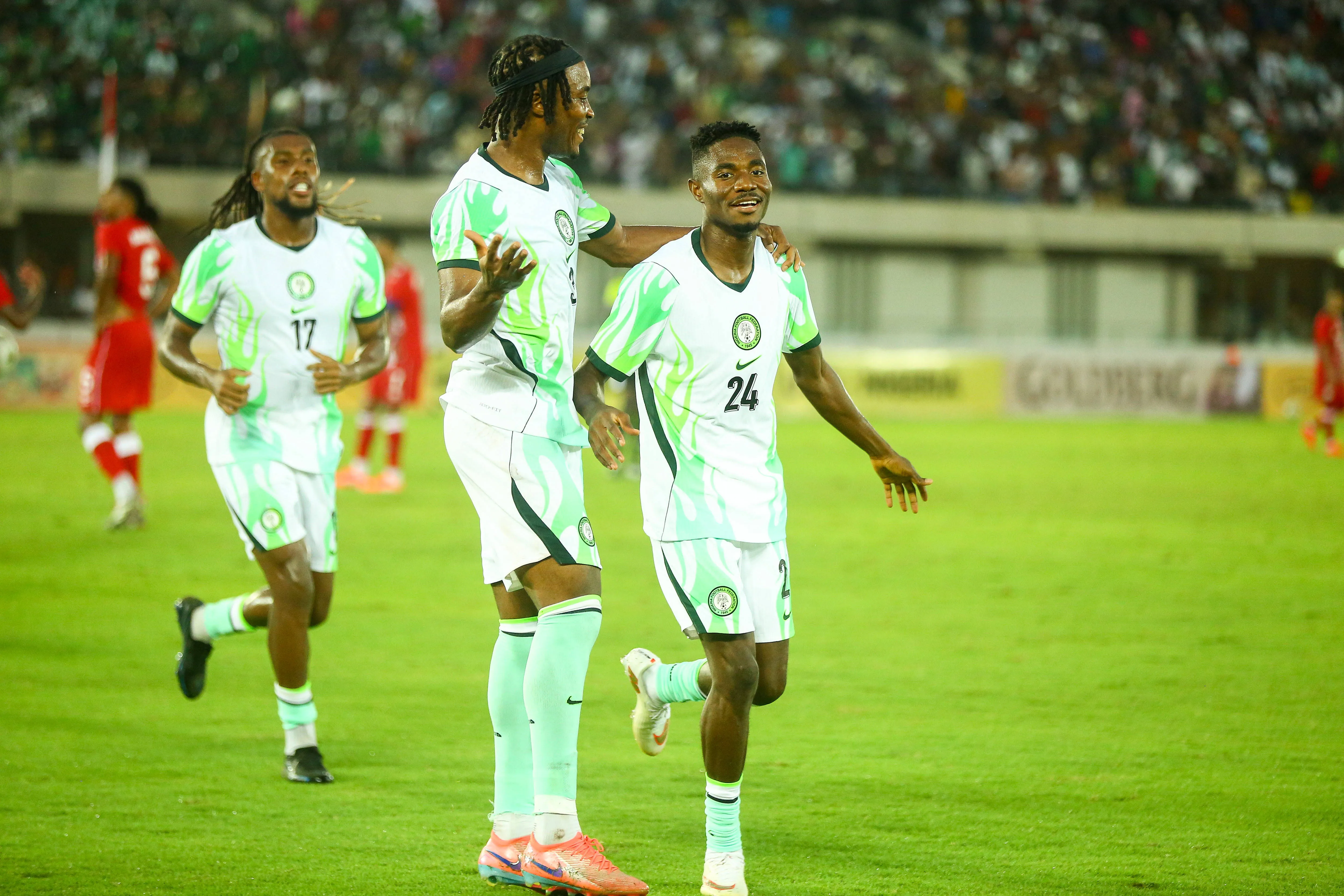 Moses Usor, Alex Iwobi, Onyemaechi Bruno of the Super Eagles of Nigeria celebrate against Madagascar