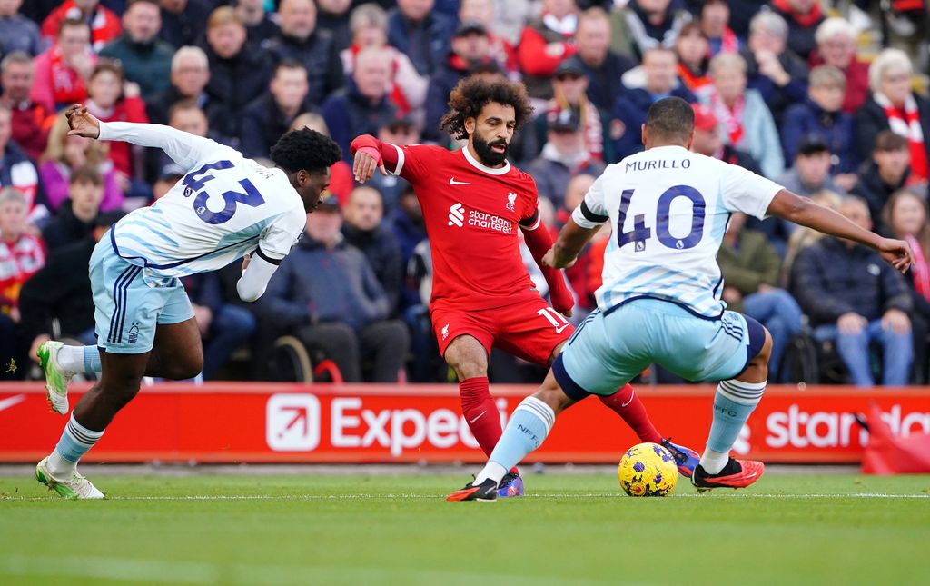 Mohamed Salah in action with Nottingham Forest's Ola Aina left and Murillo during the Premier League match at Anfield