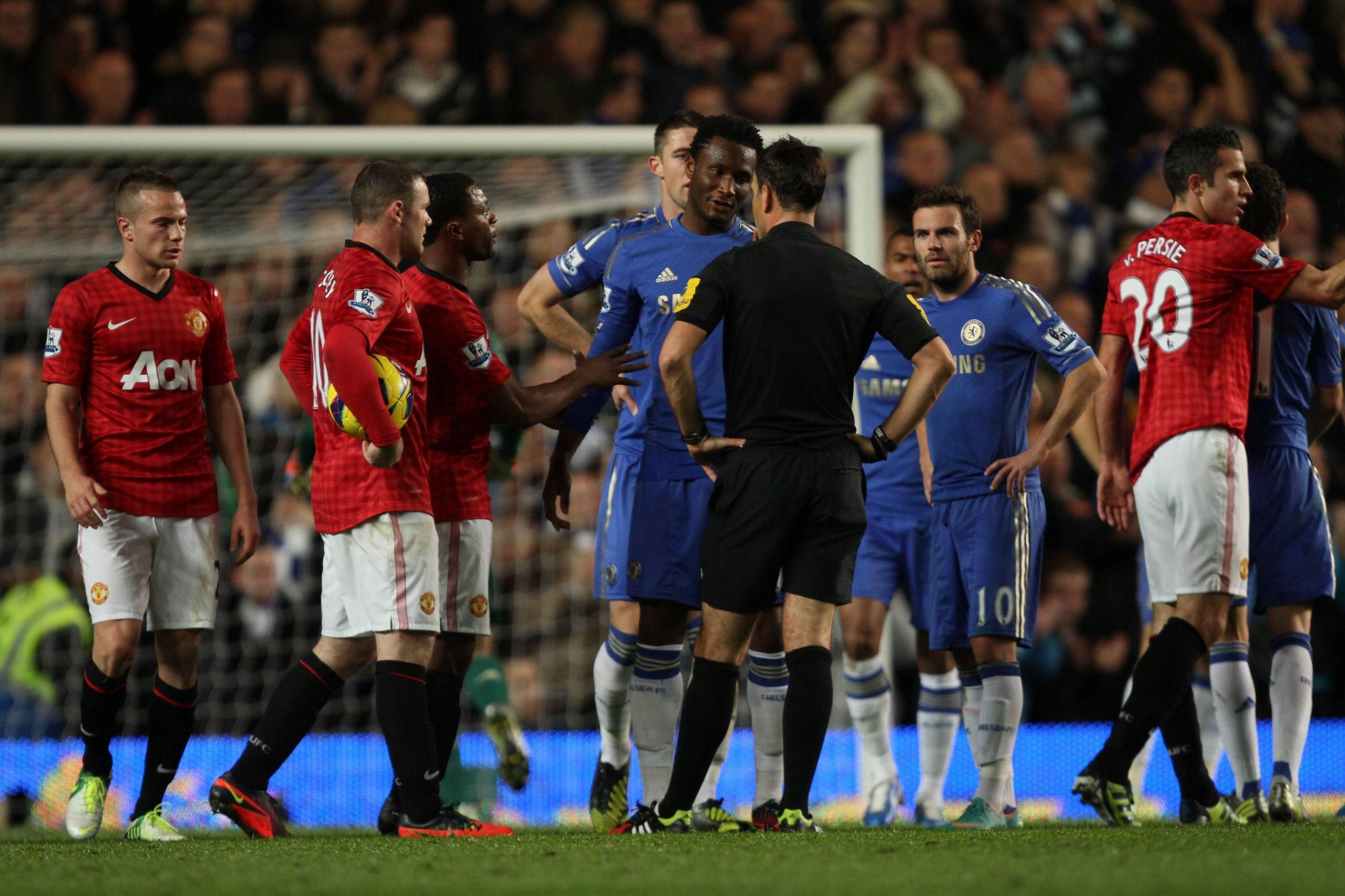 Premier League: Chelsea v Manchester United. John Mikel Obi (C) speaks to referee Mark Clattenburg