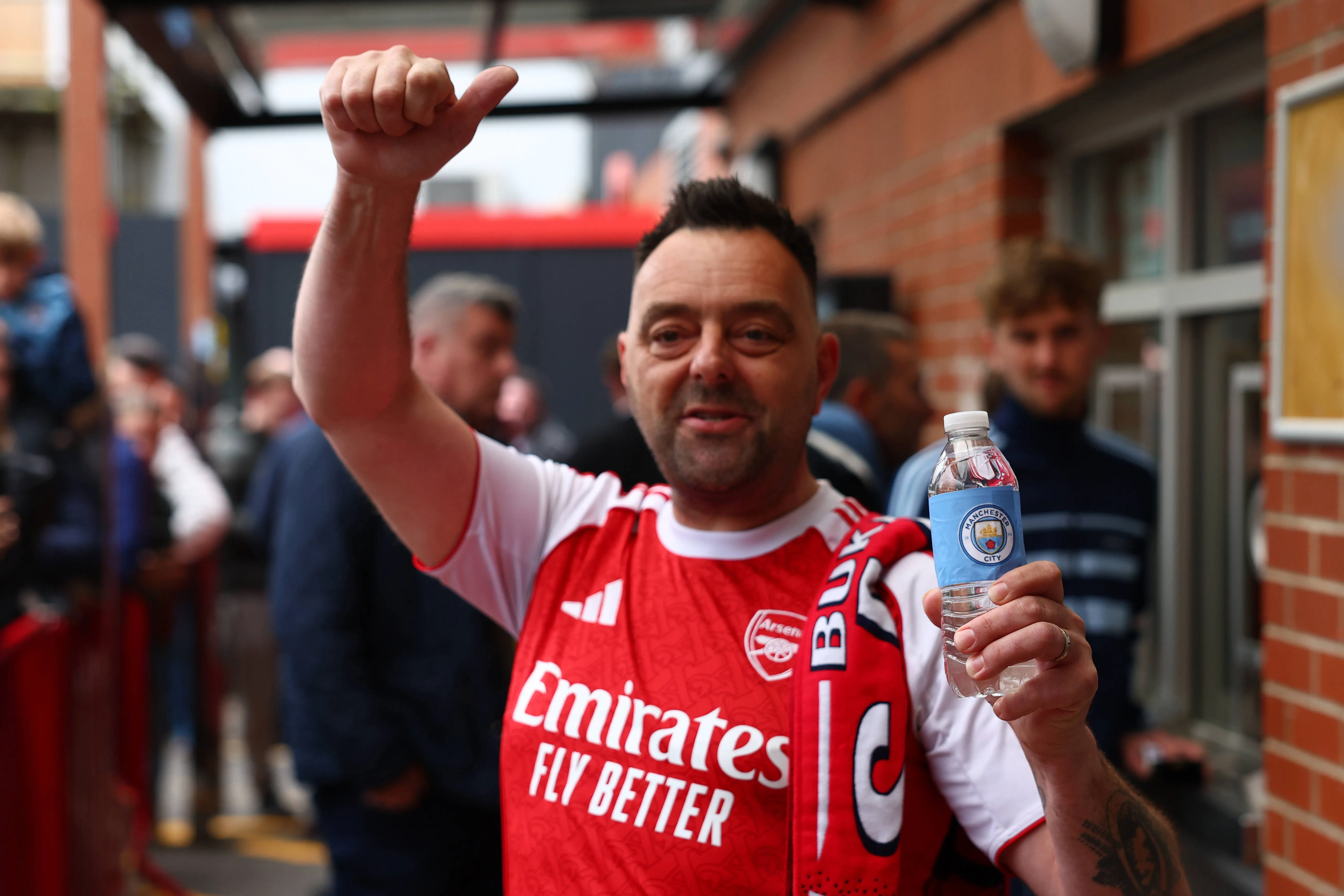 A supporter wearing an Arsenal shirt holding a Manchester City branded bottle during the AFC Bournemouth vs Manchester City Premier League match