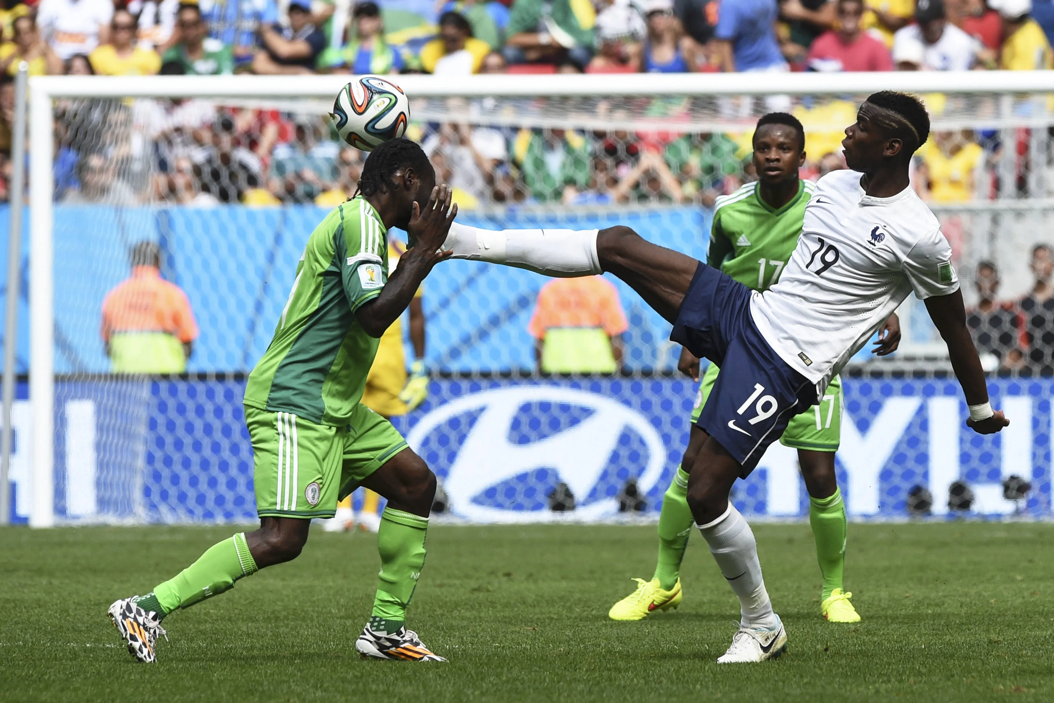 Victor Moses, Paul Pogba and Ogenyi Onazi battle for the ball in France's battle against Nigeria at the 2014 FIFA World Cup