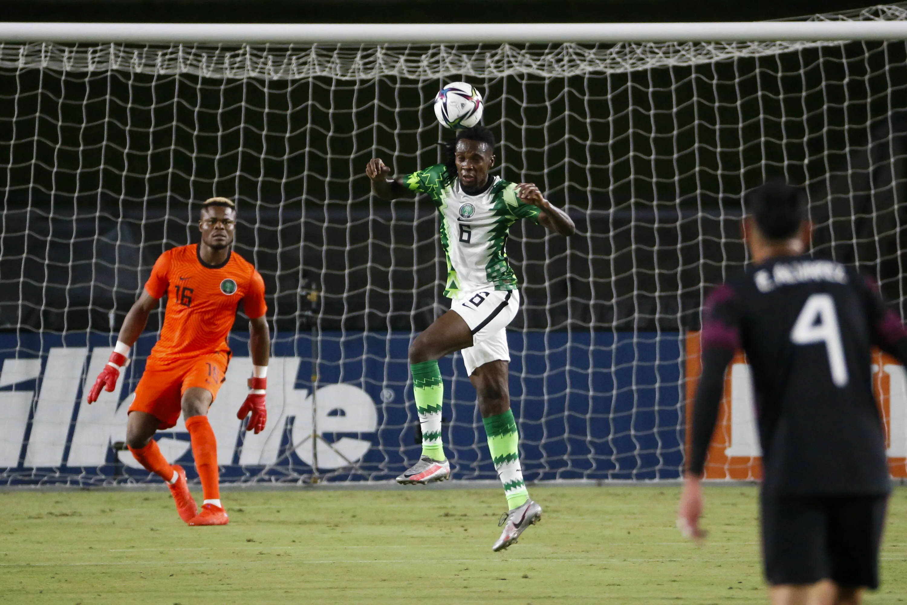 Olisa Ndah heads the ball