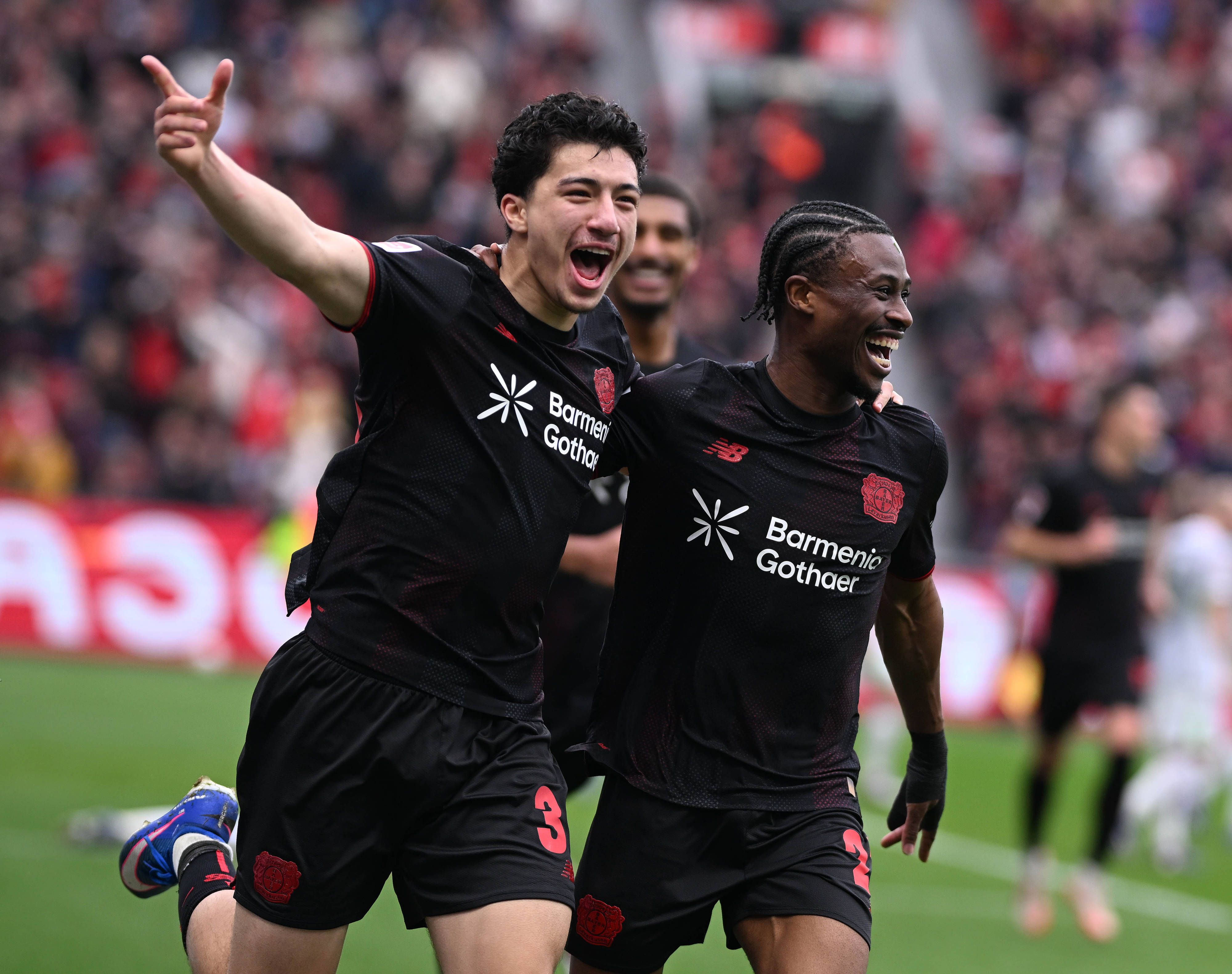 Nathan Tella celebrates with Ibrahim Maza for Bayer Leverkusen