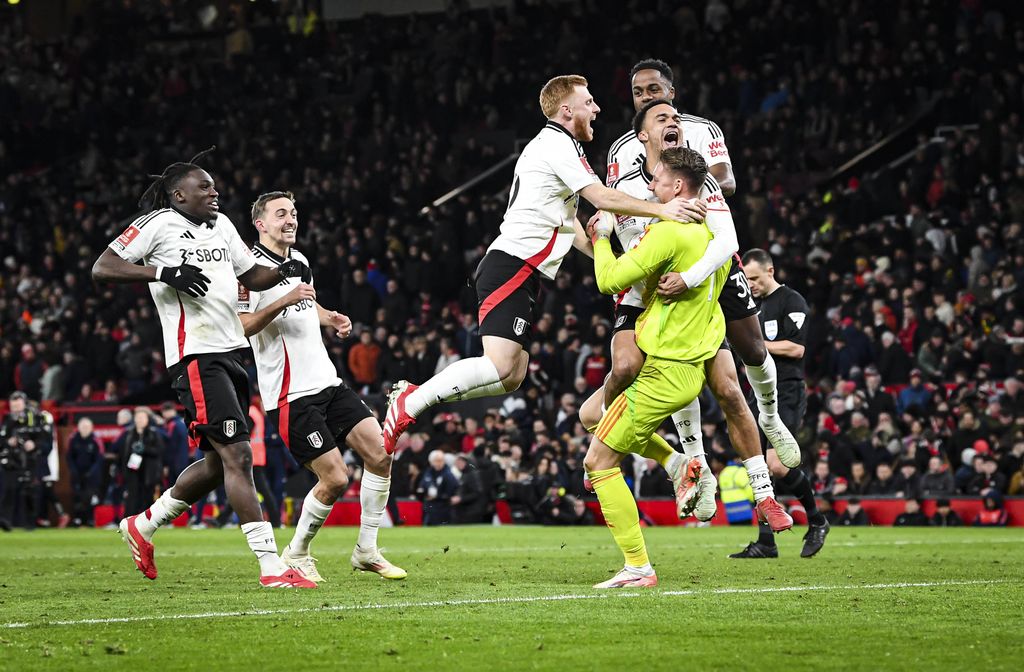 Fulham players celebrate with their goalkeeper Bernd Leno who saved two penalties to win the match 5-3 in the penalty shoot out