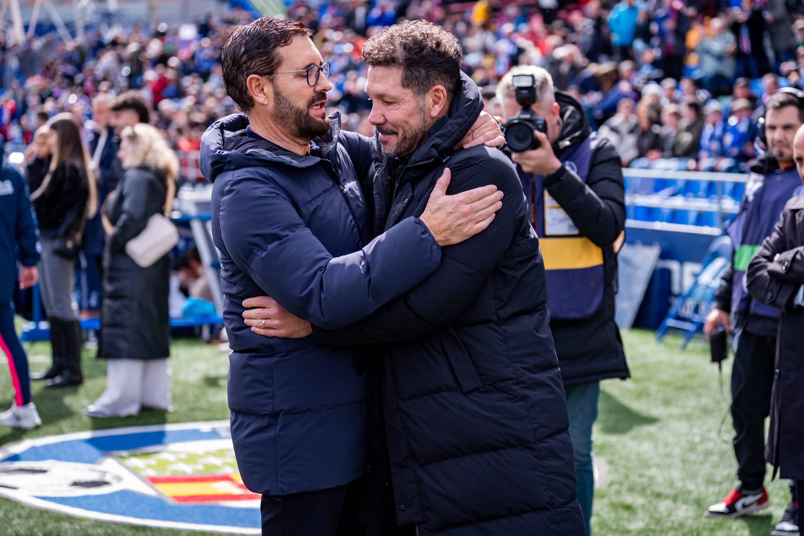 Jose Bordalas L, head coach of Getafe CF, hugs Diego Pablo Simeone R, head coach of Atletico de Madrid