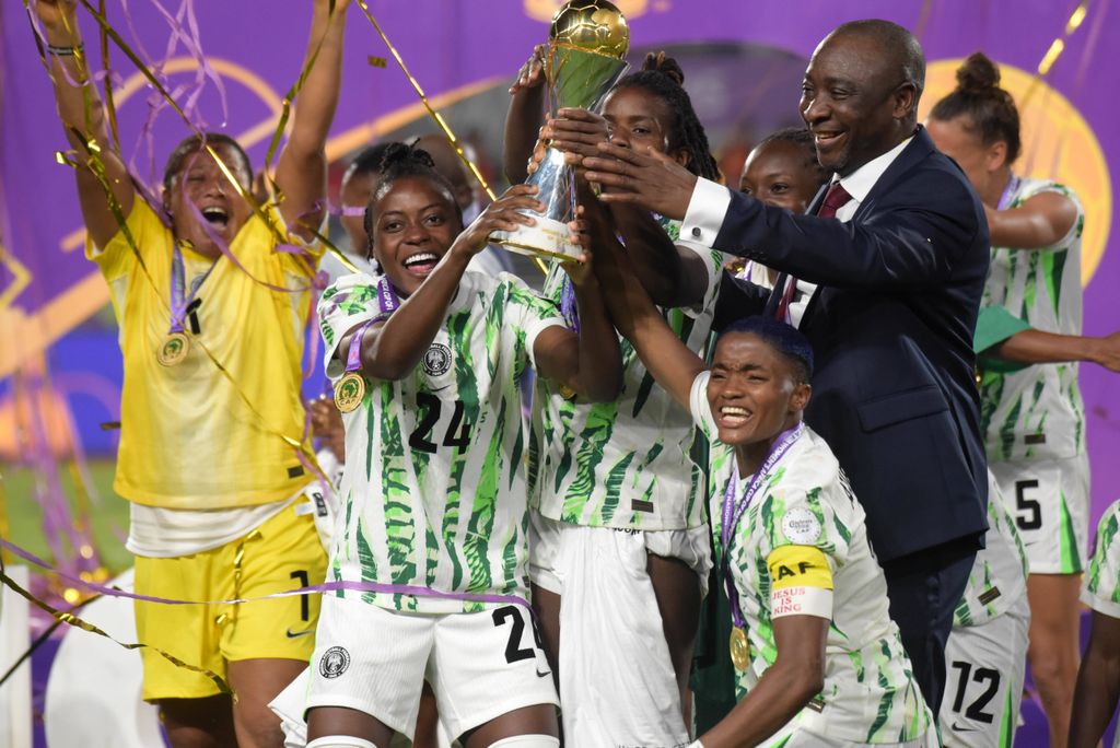 Rasheedat Ajibade and Chioma Okafor of Super Falcons celebrate WAFCON title with NFF President Ibrahim Gusau