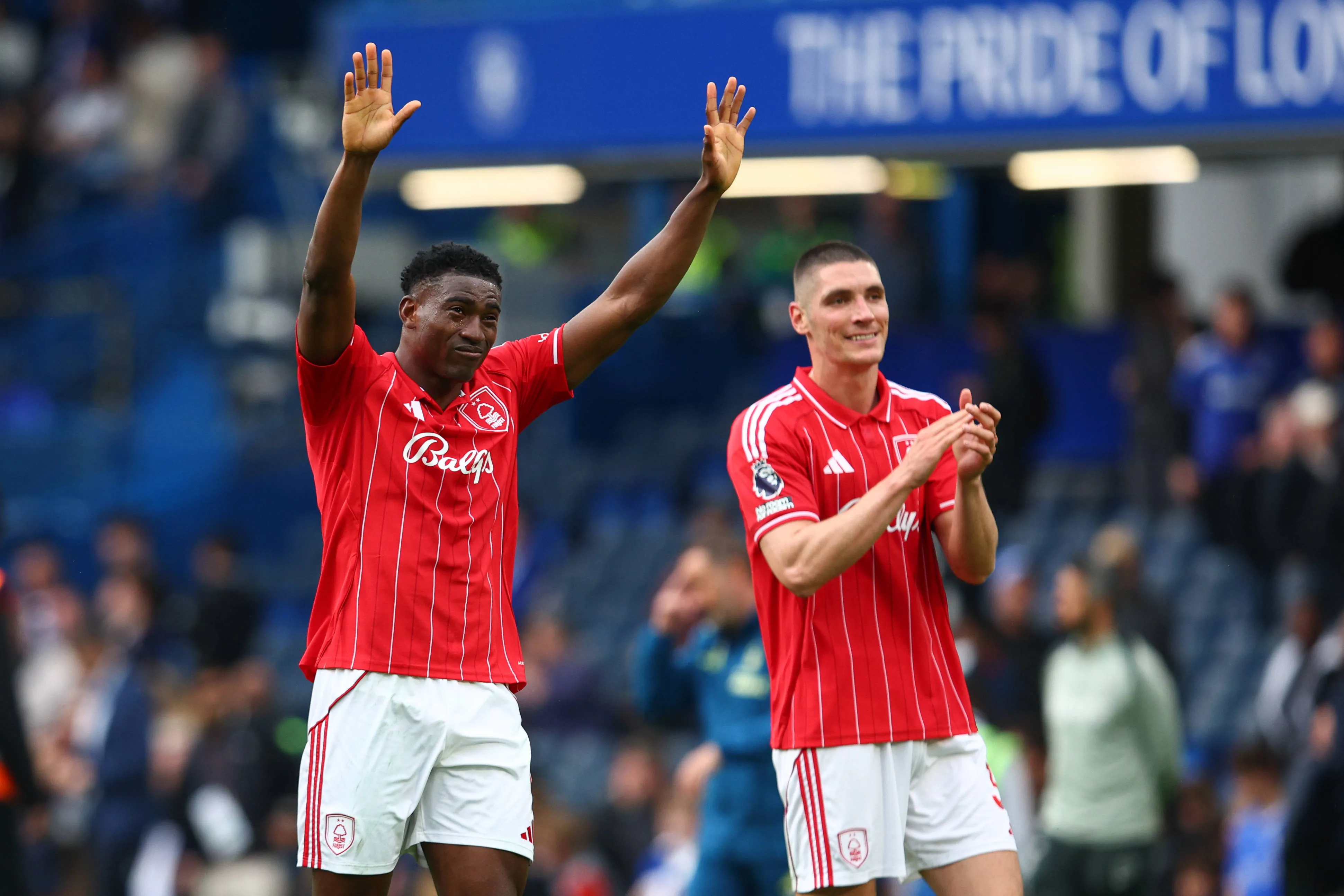 Taiwo Awoniyi and Nikola Milenkovic of Nottingham Forest celebrate after the Premier League match between Chelsea FC and Nottingham Forest FC at Stamford Bridge London Stamford Bridge.