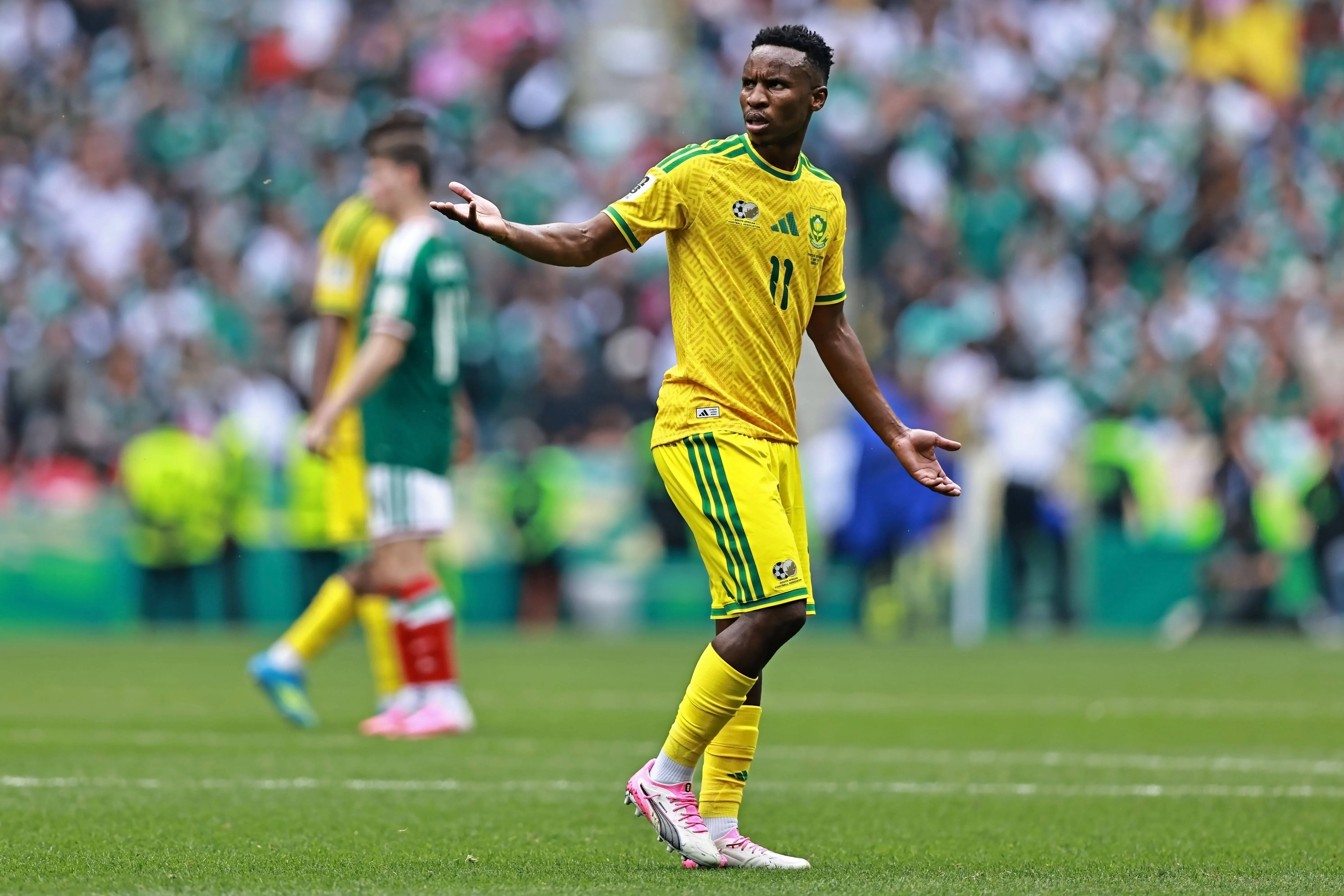 Themba Zwane of South Africa gestures after receiving a red card